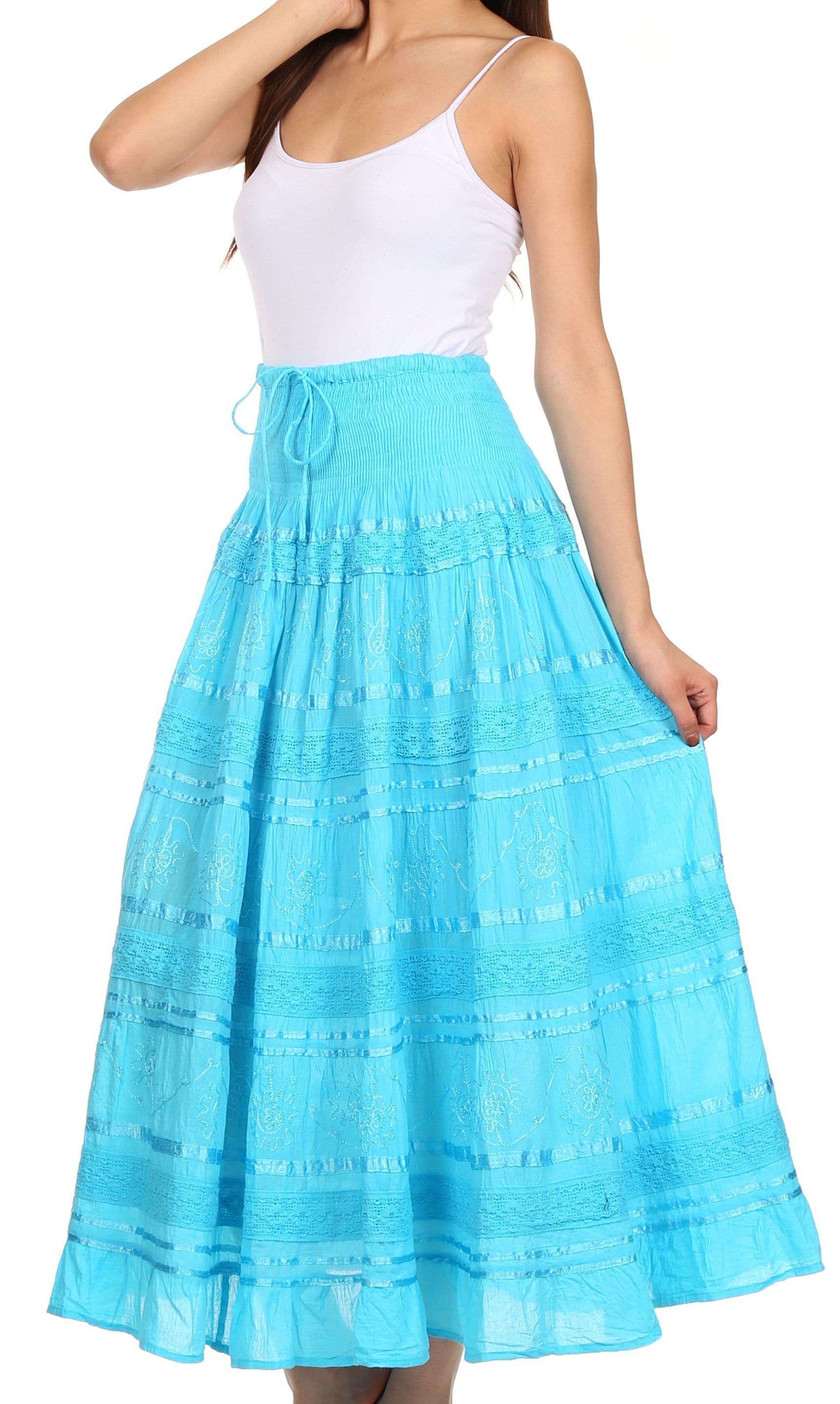 Woman wearing a blue skirt with a white top on a white background