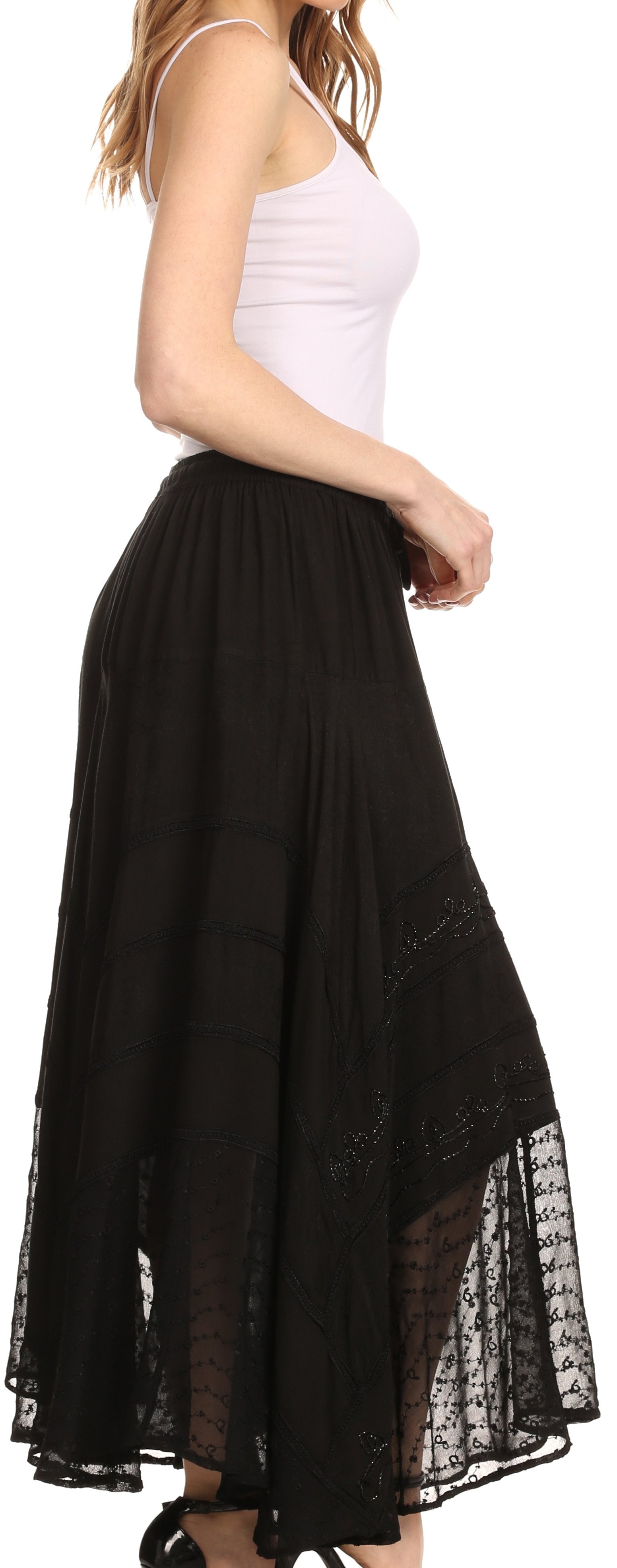 Black lace-trimmed skirt worn by a person on a white background