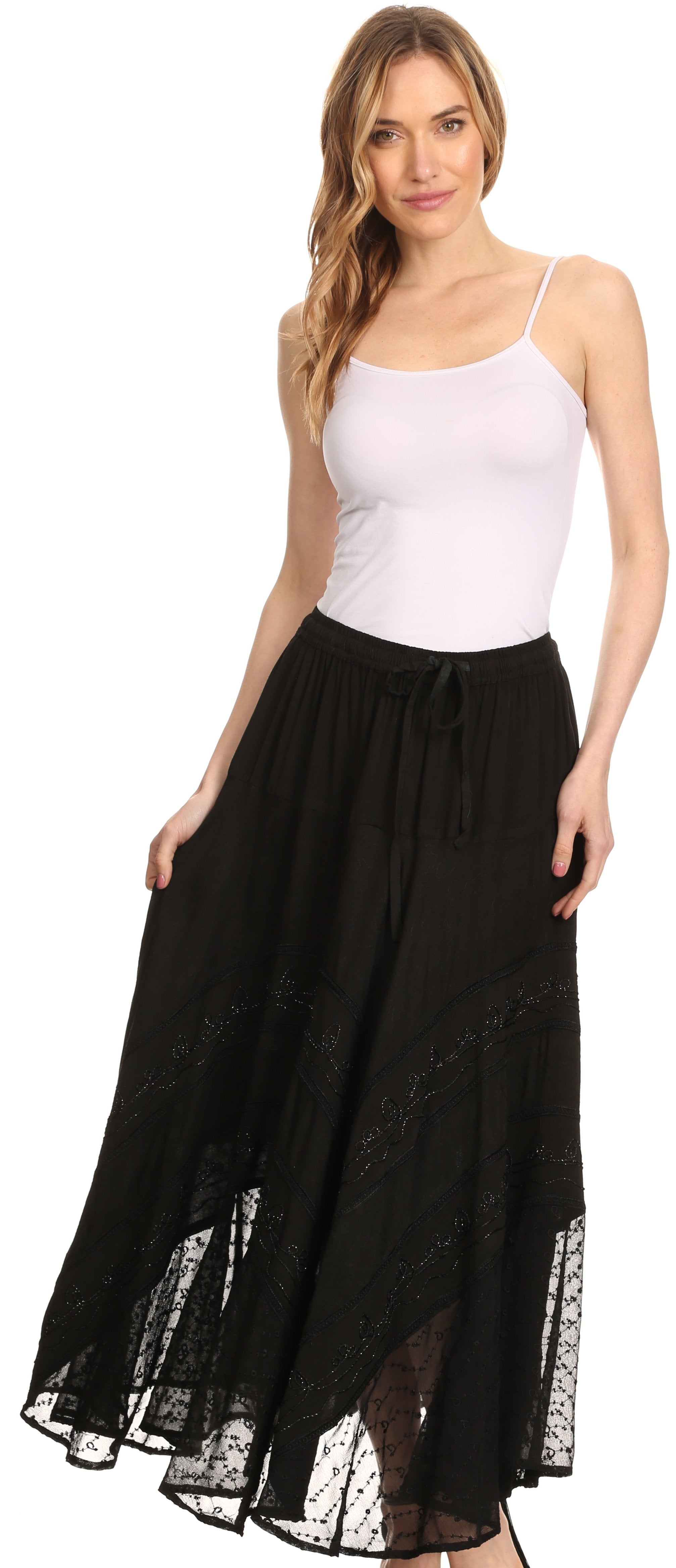 Woman wearing a white tank top and black lace-trimmed skirt on a white background
