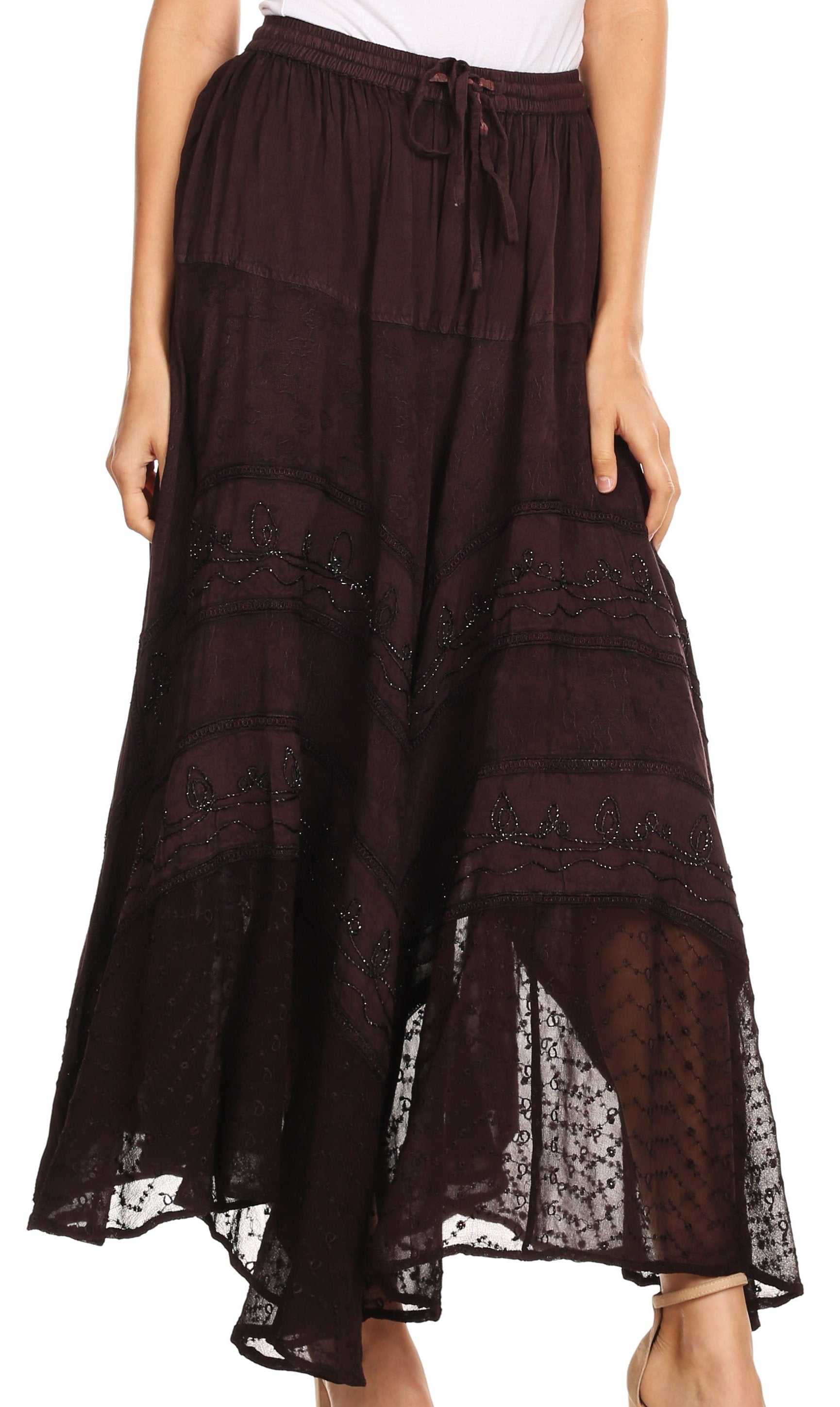 Brown lace skirt worn by a person on a white background