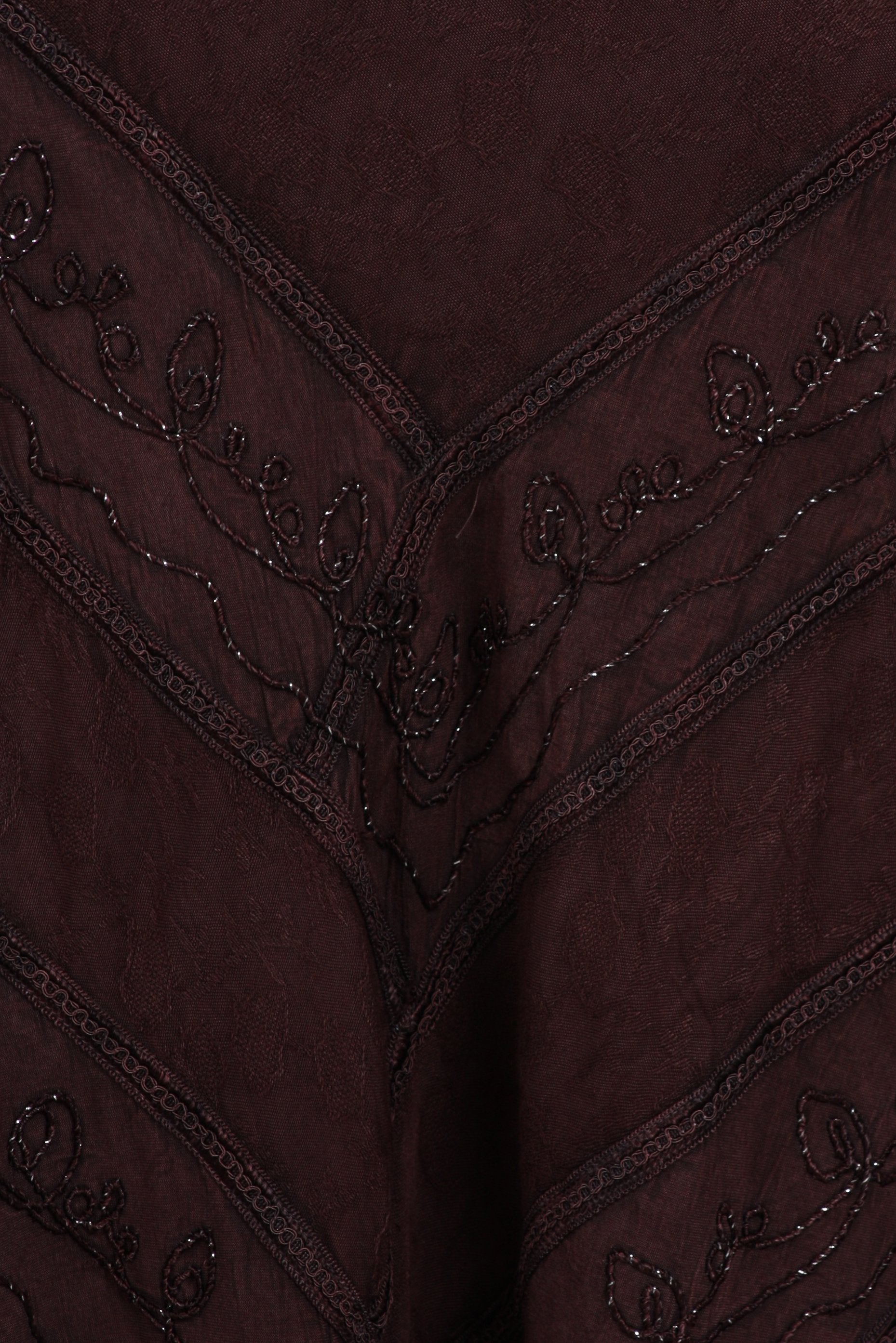 Close-up of a dark brown fabric with intricate beadwork