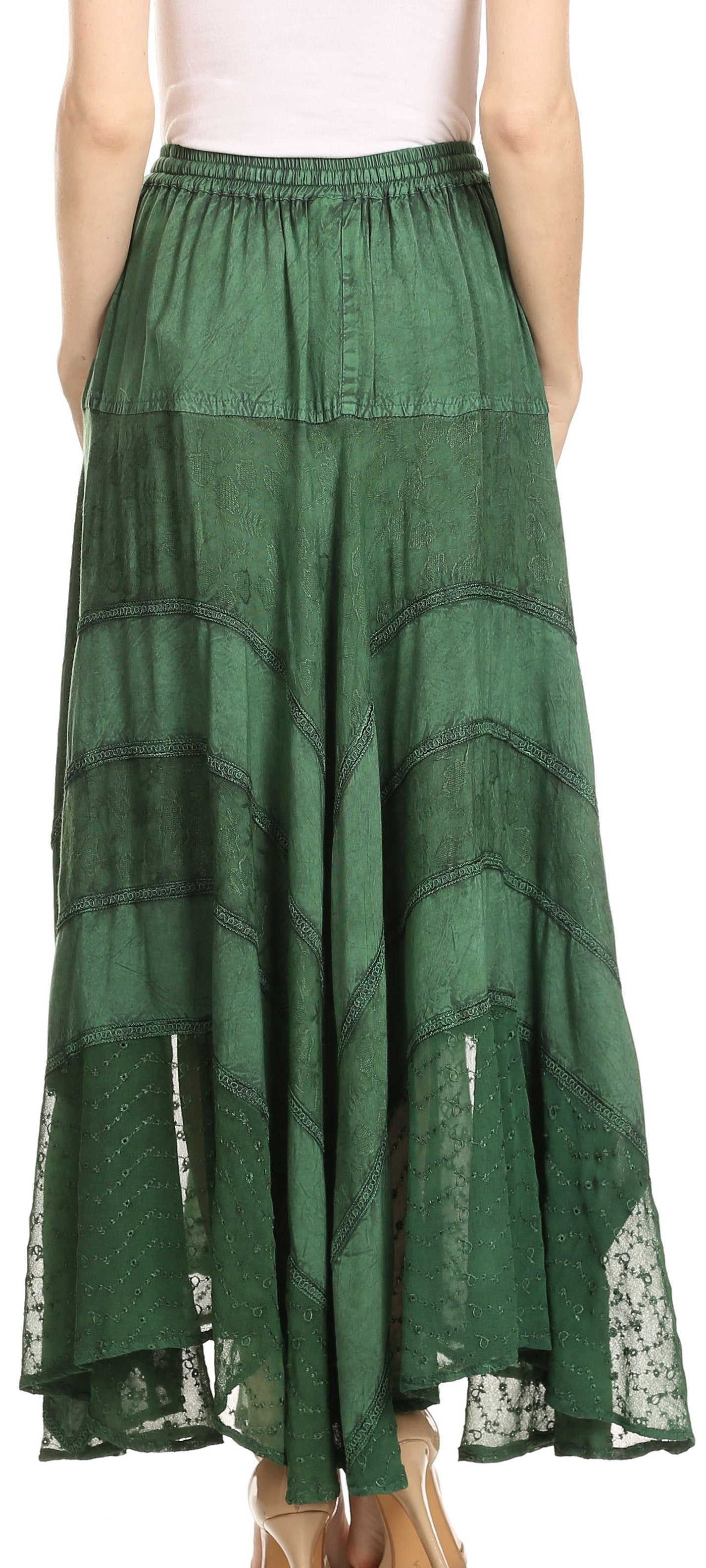 Green tiered skirt with lace details worn by a person on a white background
