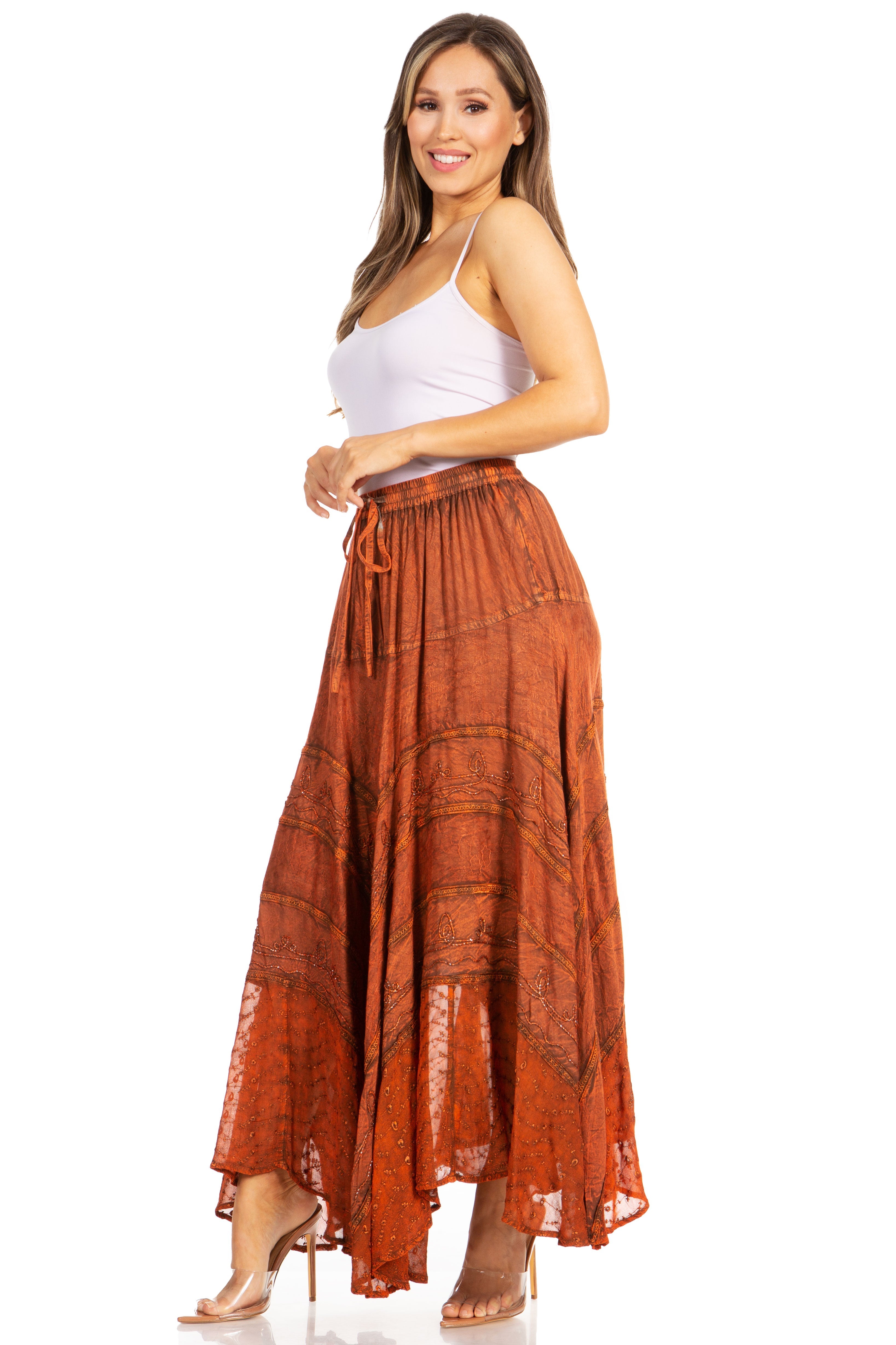 Woman wearing a white top and rust-colored skirt on a white background