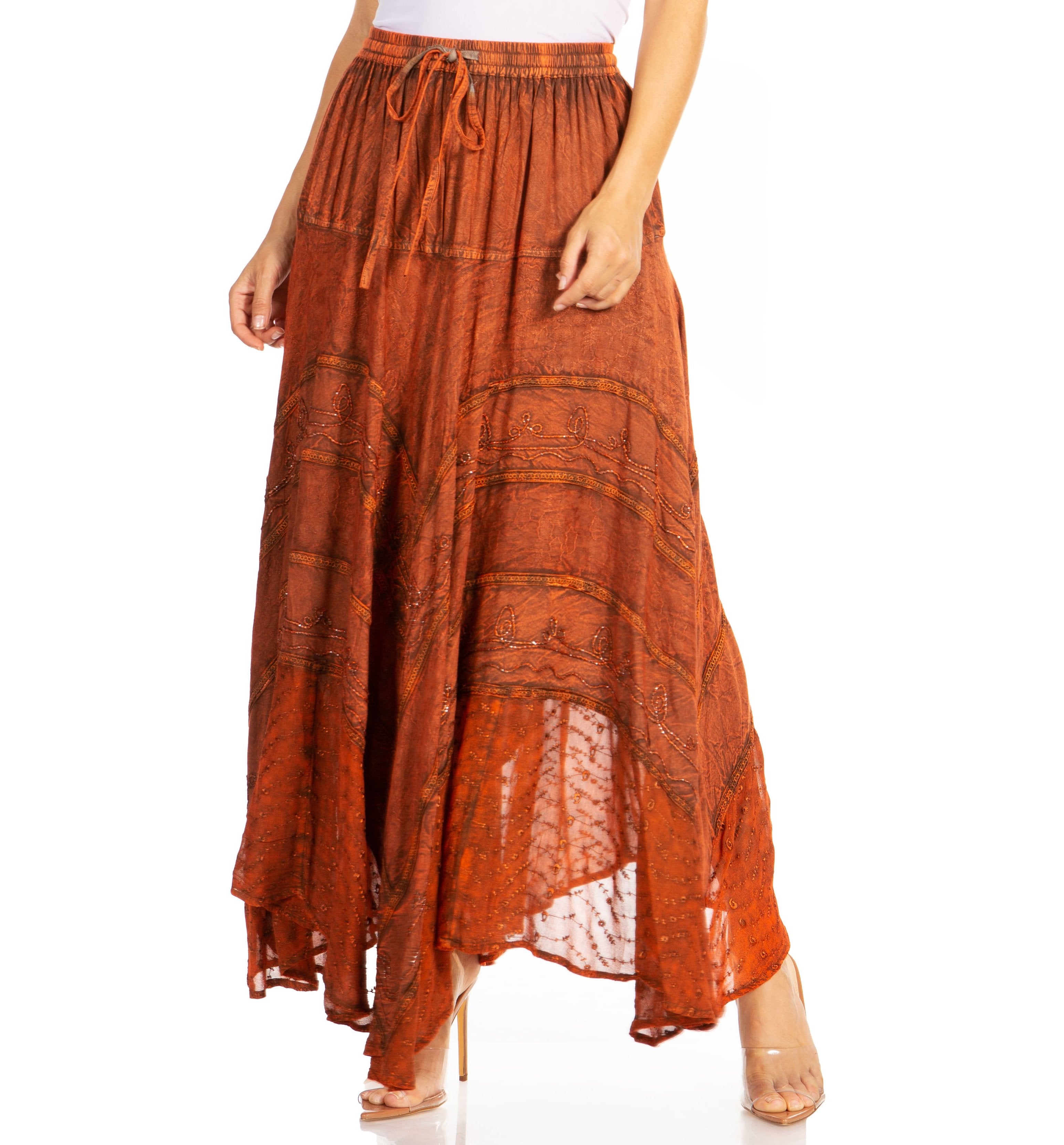 Orange patterned skirt worn by a person on a white background