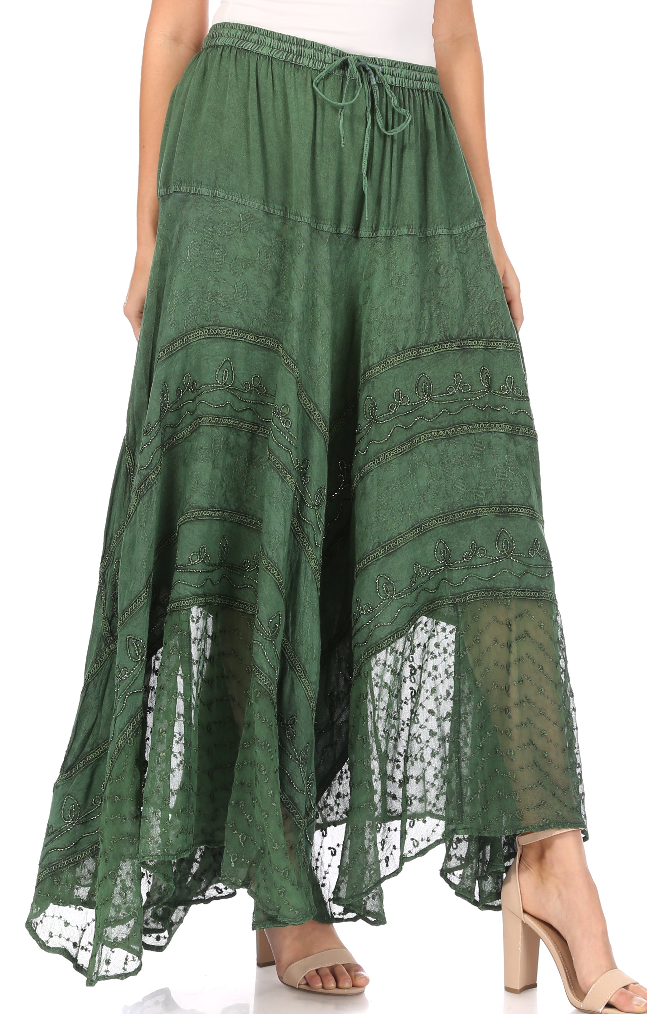 Green lace-trimmed skirt worn by a person on a white background