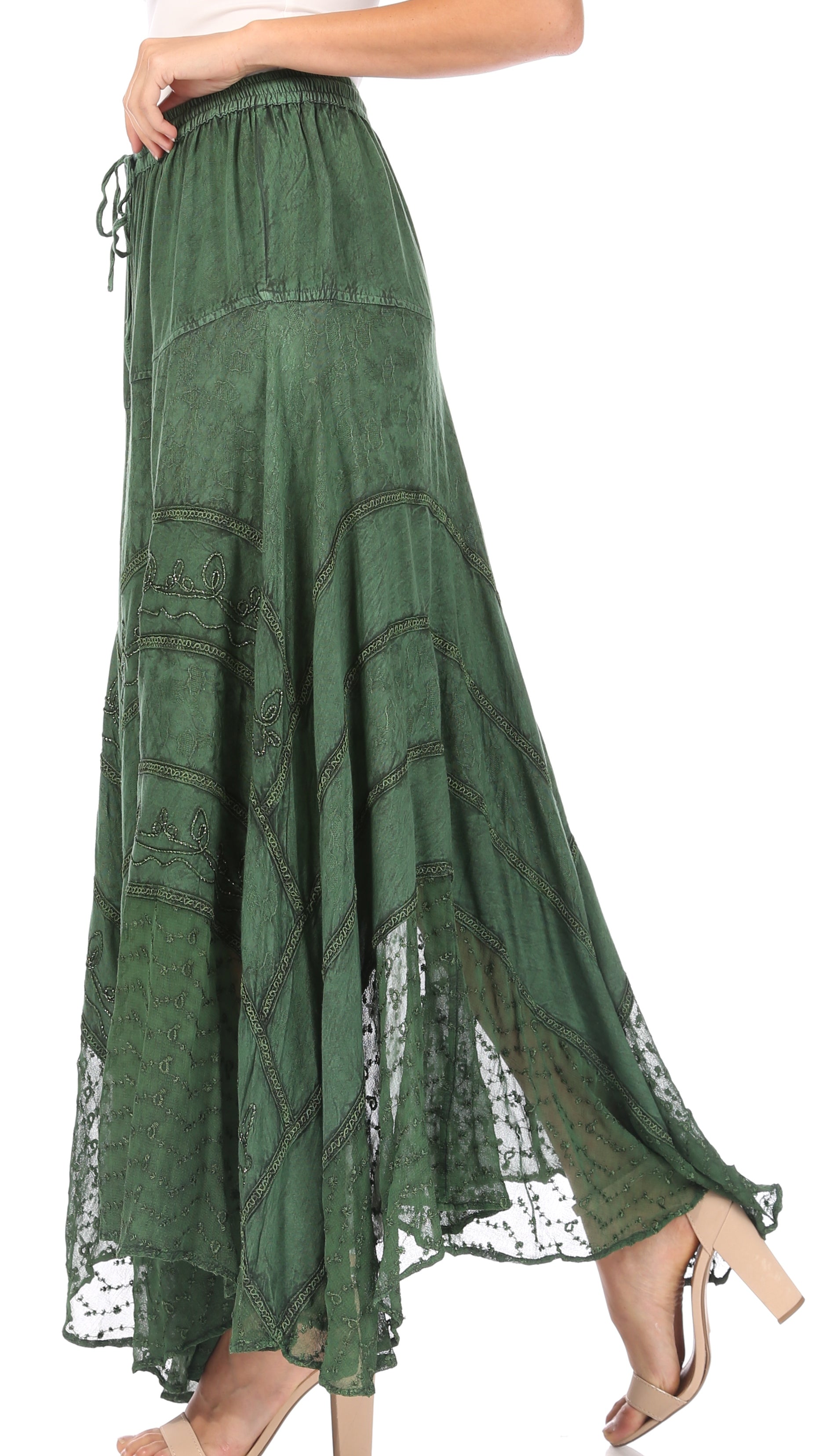 Green lace-trimmed skirt worn by a person on a white background