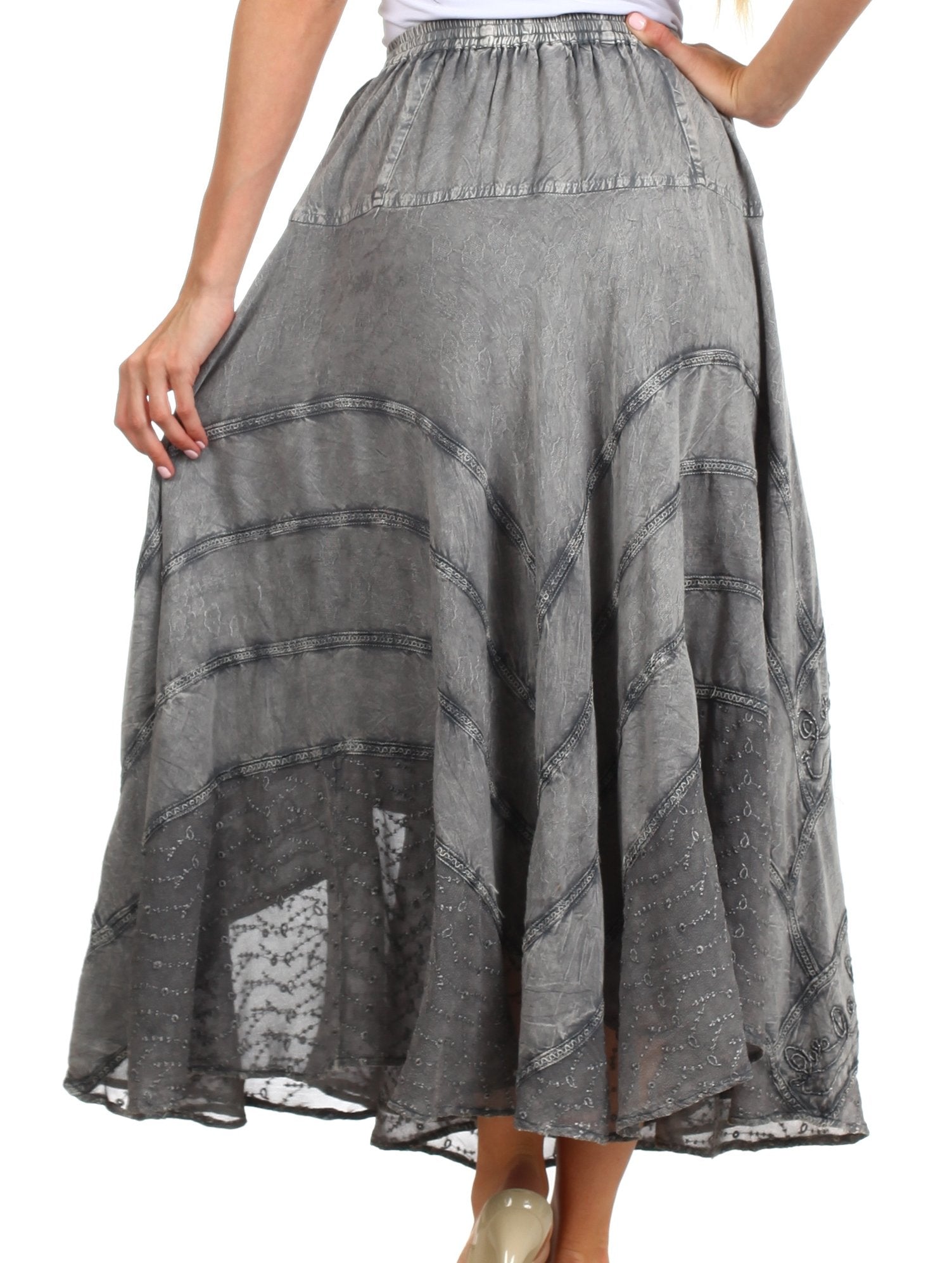 Gray patterned skirt worn by a person on a white background