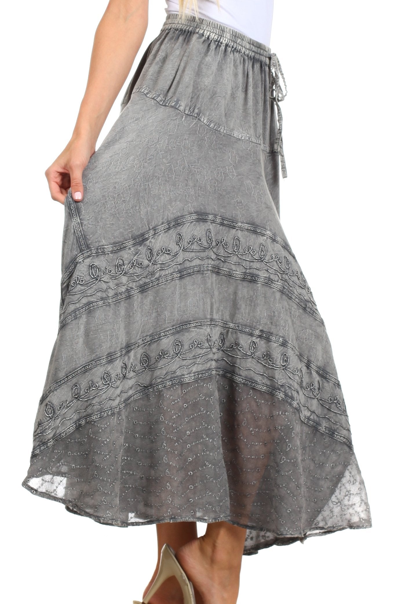 Gray patterned skirt worn by a person on a white background