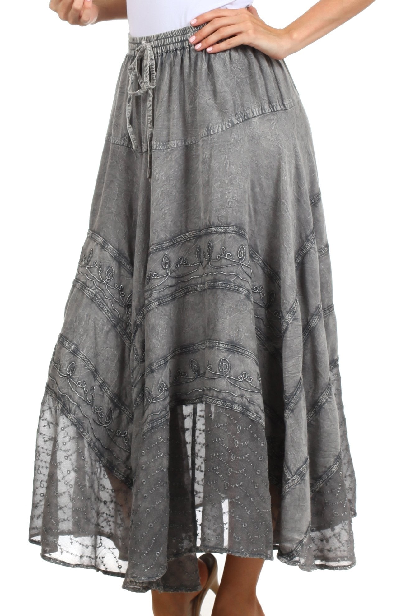 Gray patterned skirt worn by a person on a white background