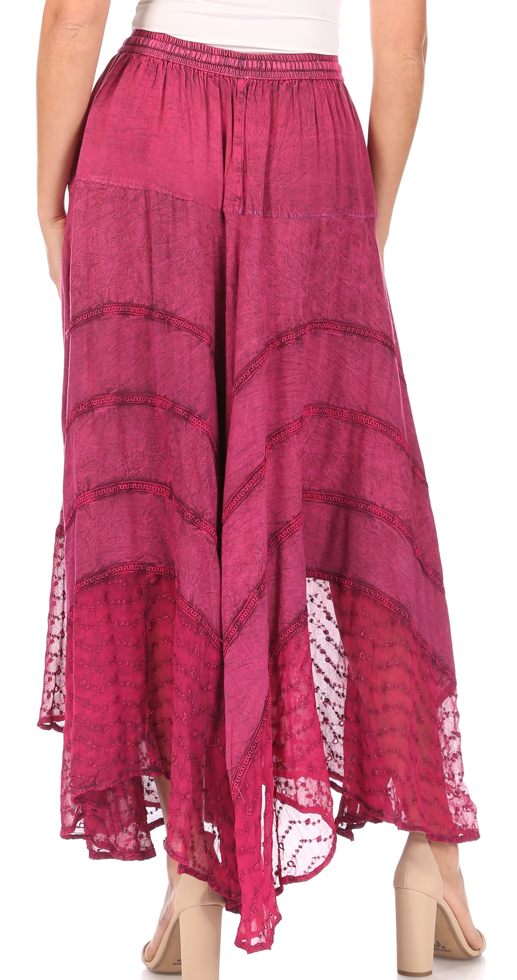 Pink patterned skirt worn by a person on a white background