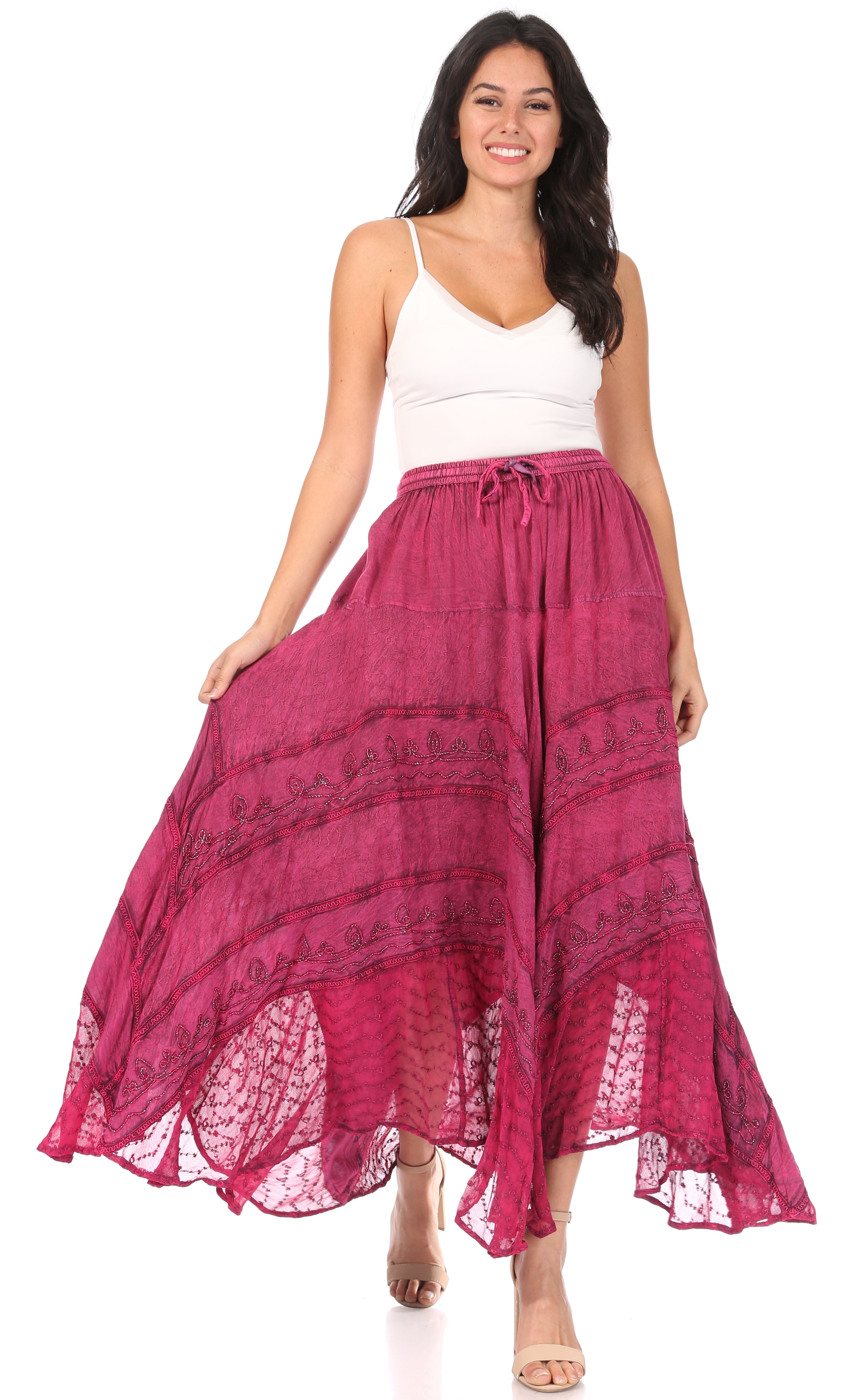 Woman wearing a white top and pink lace skirt on a white background