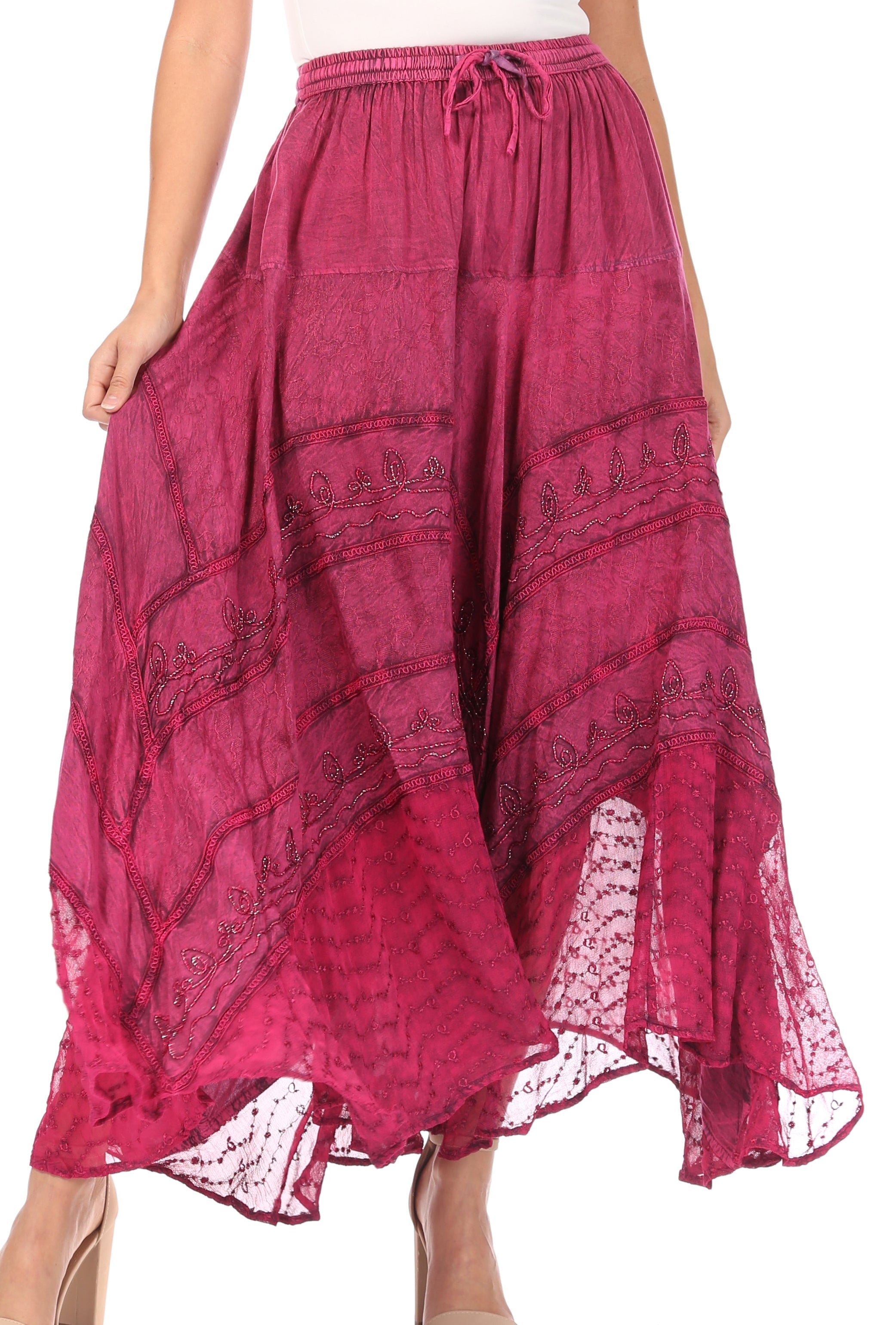 Pink patterned skirt with lace trim worn by a person on a white background