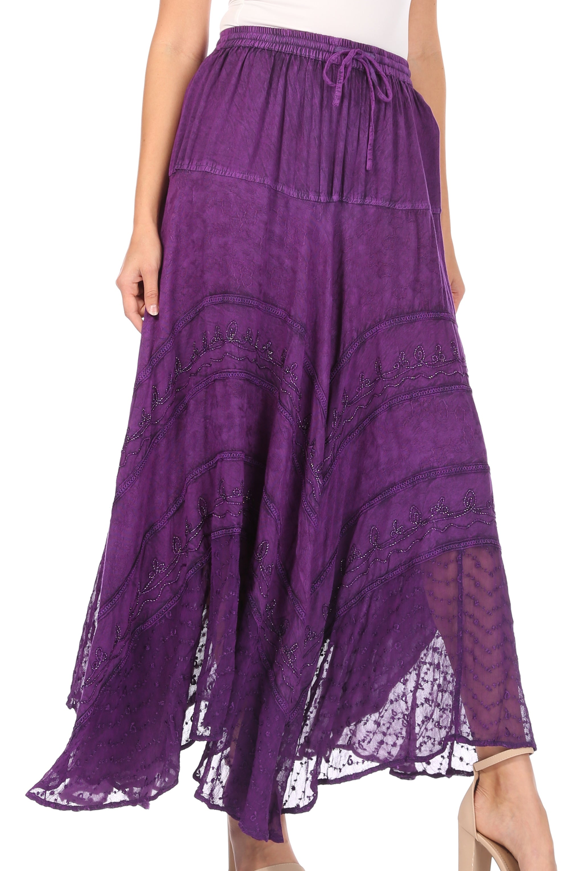 Purple lace skirt worn by a person on a white background