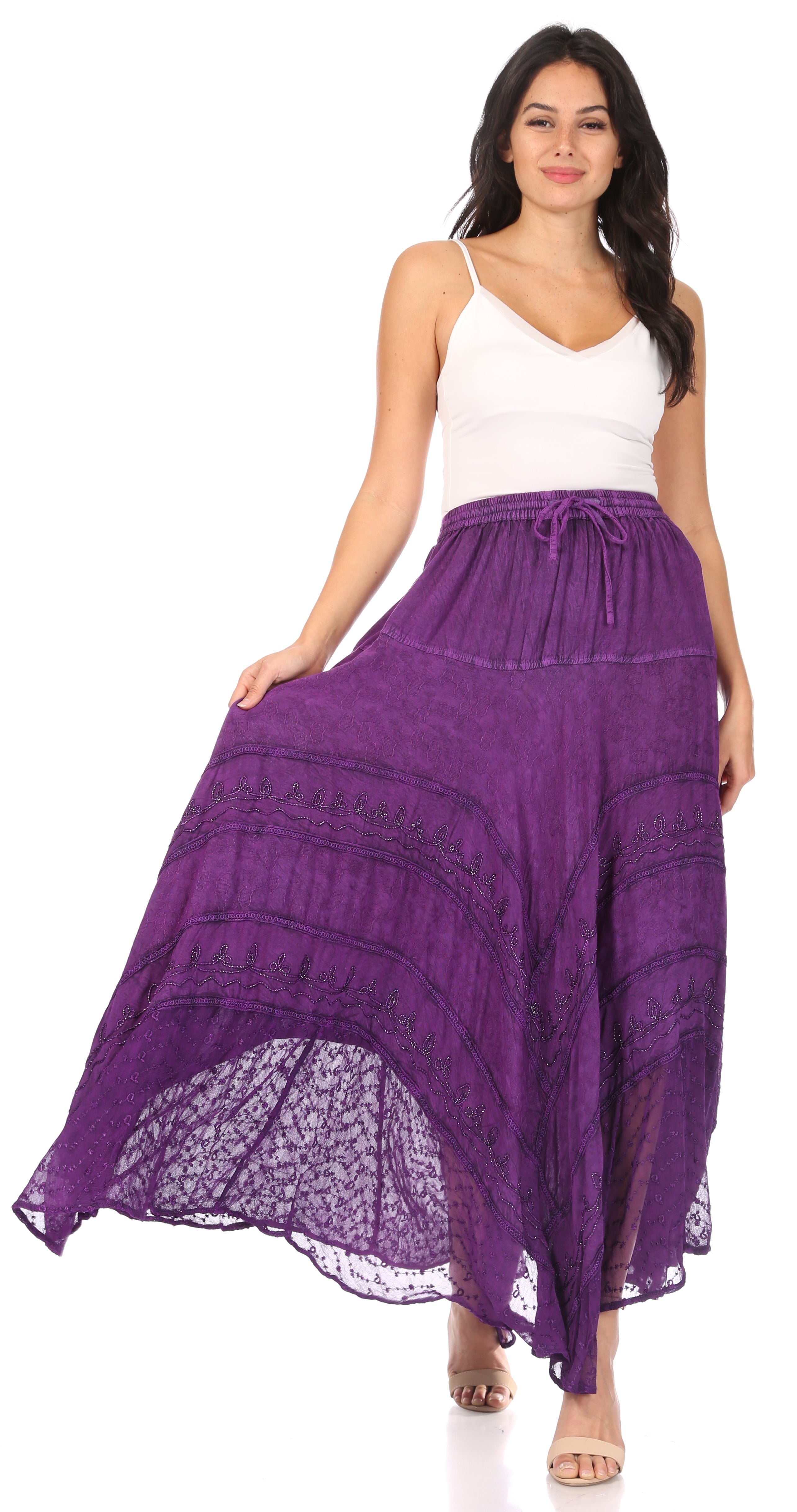 Woman wearing a long purple skirt with a white top on a white background