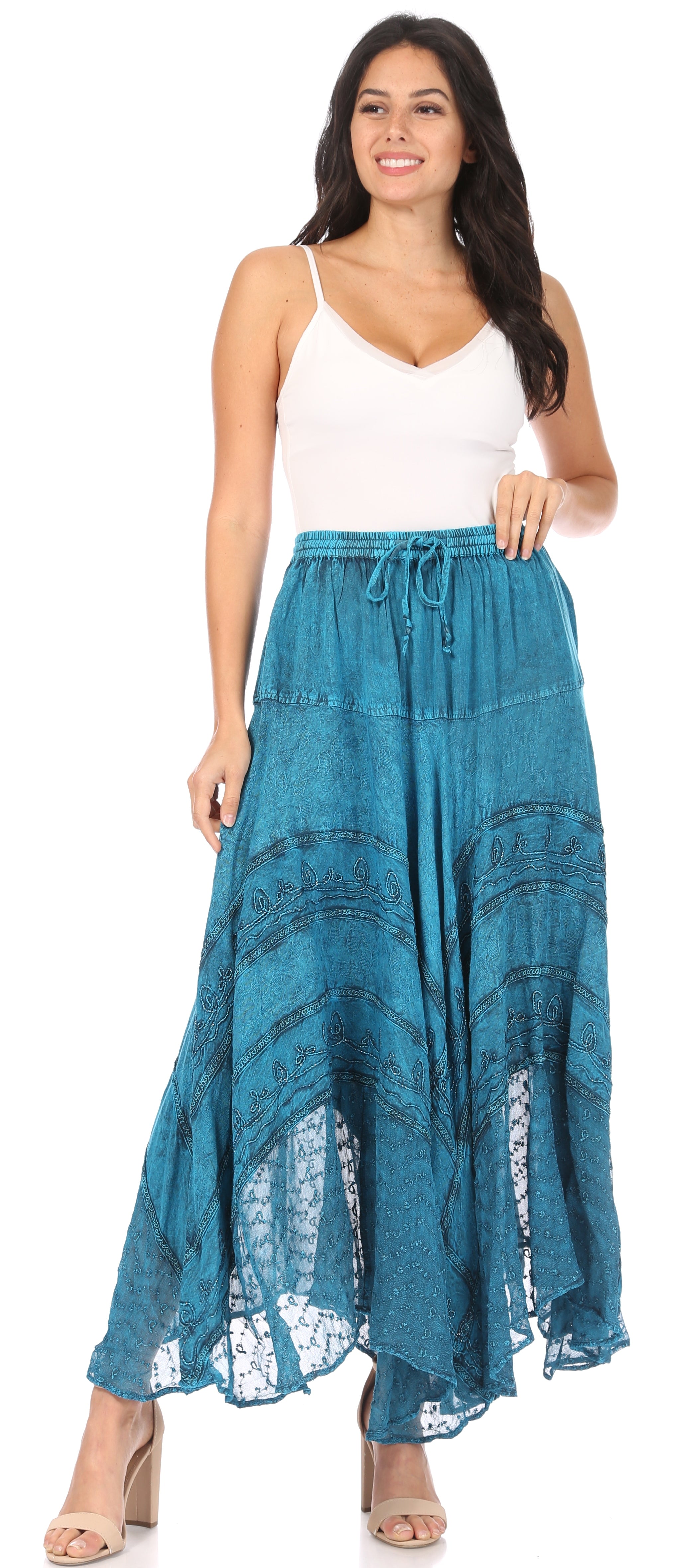 Woman wearing a white top and blue lace skirt on a white background