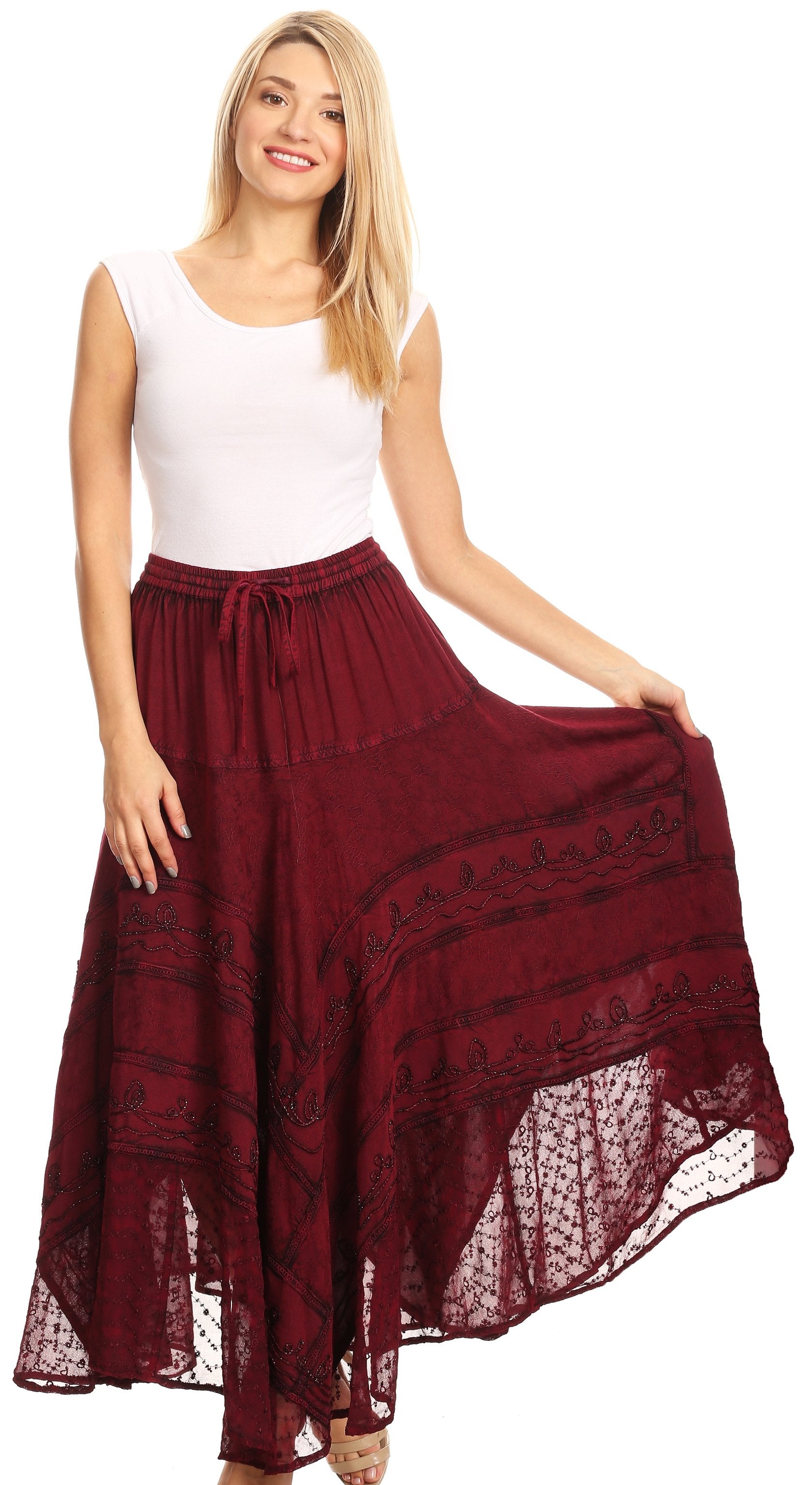 Woman wearing a white top and burgundy skirt with lace details on a white background