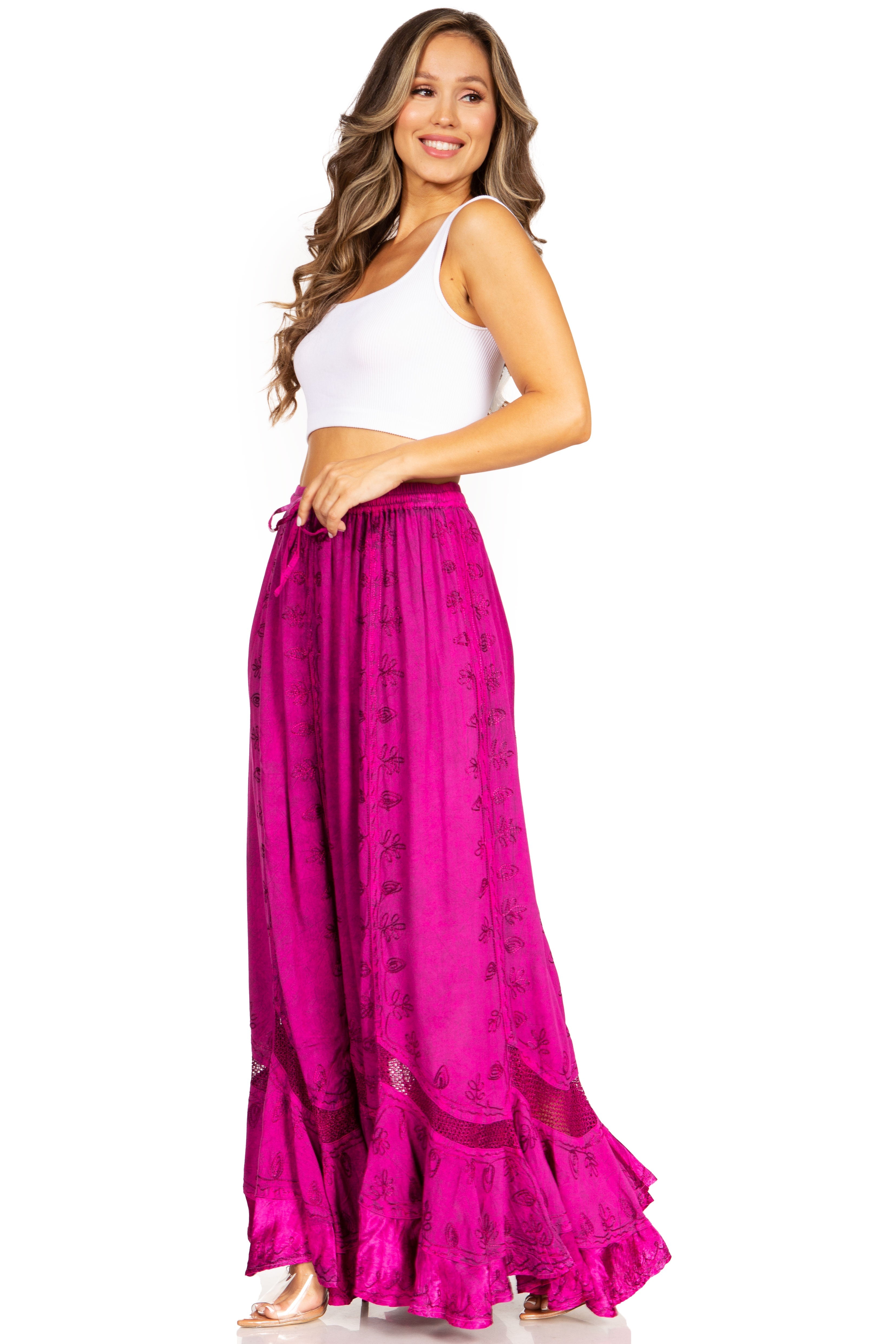 Woman wearing a white top and pink skirt on a white background