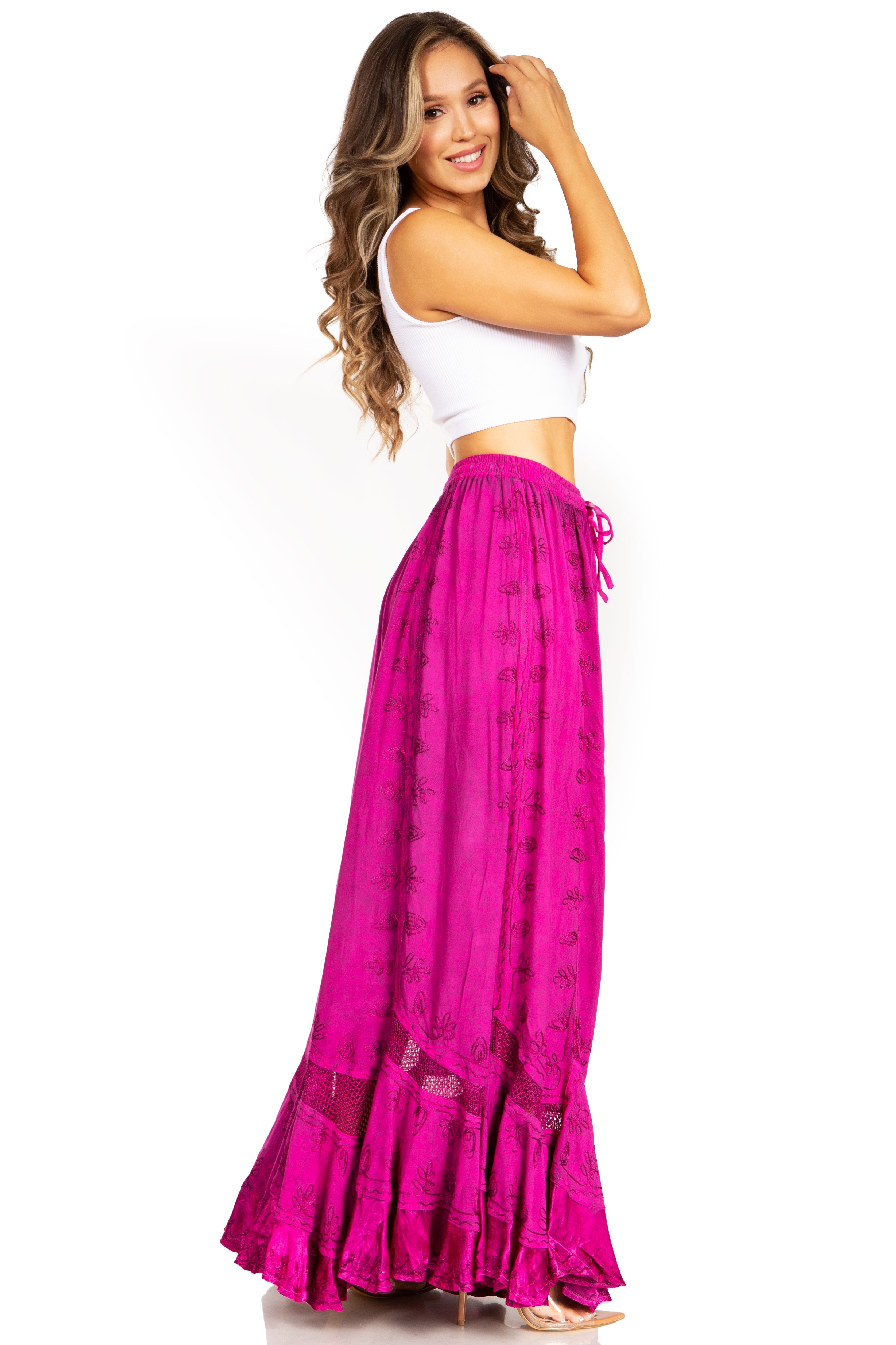 Woman wearing a white top and pink skirt on a white background