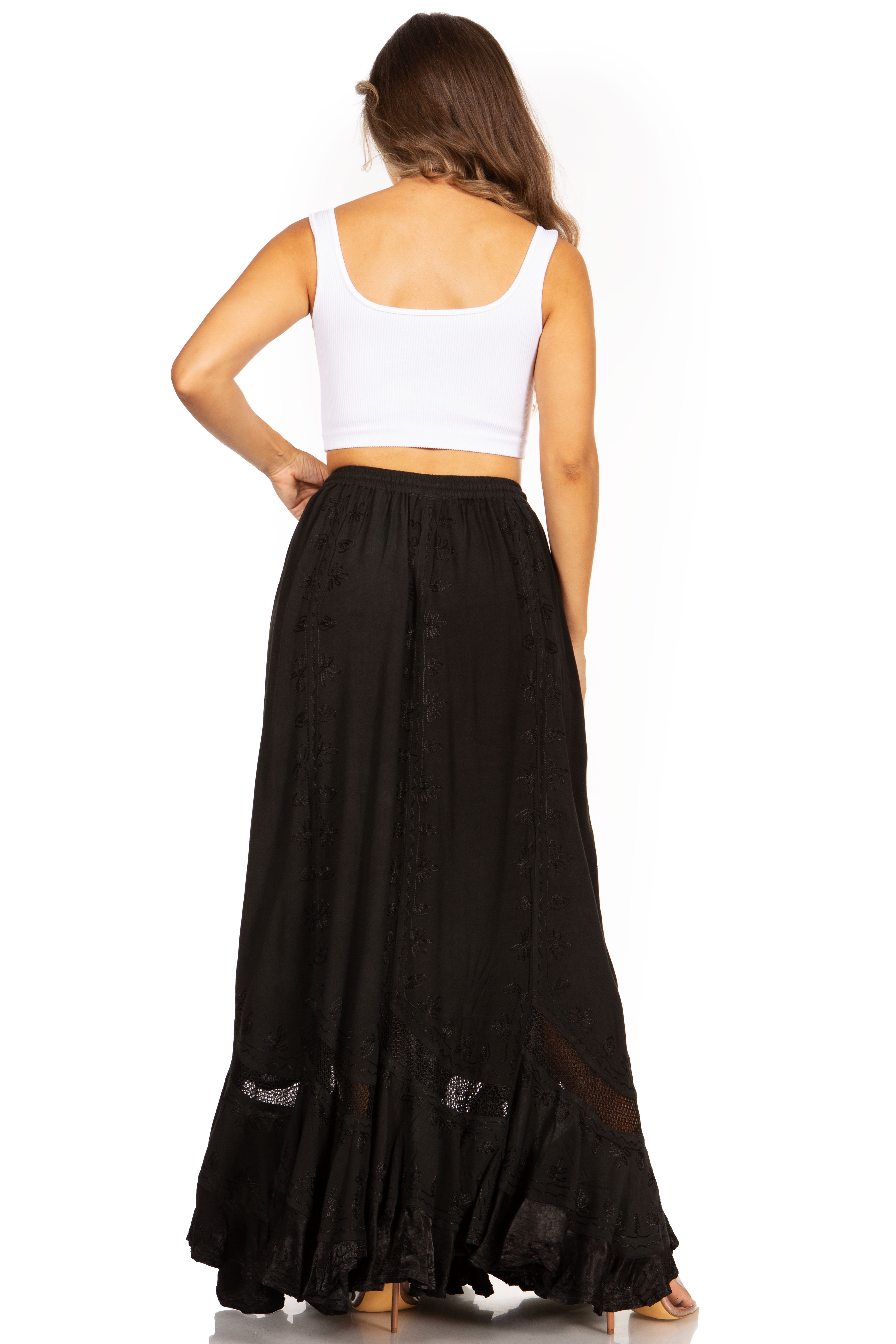 Woman wearing a long black skirt and white top on a white background