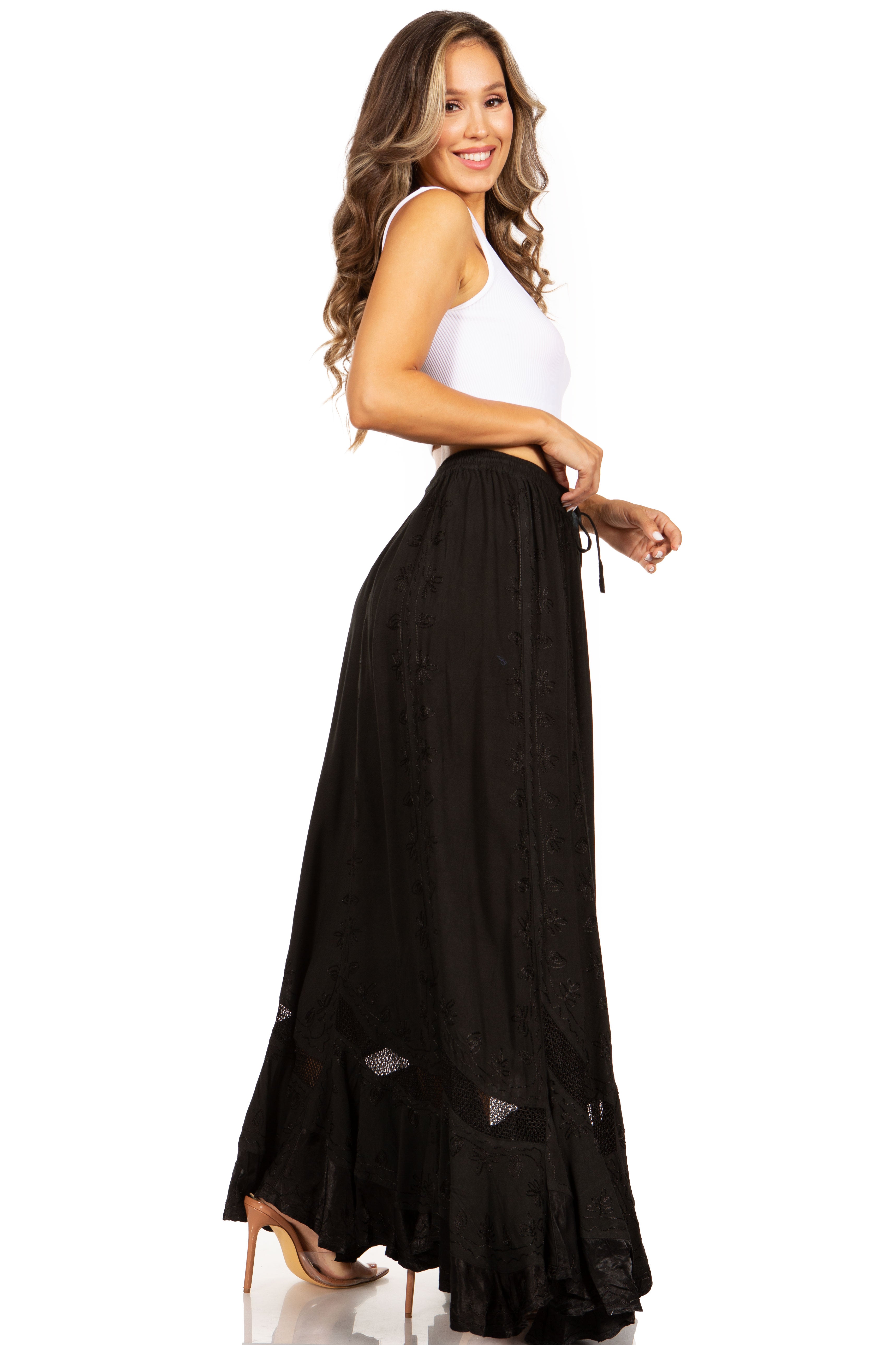 Woman wearing a white top and black long skirt on a white background