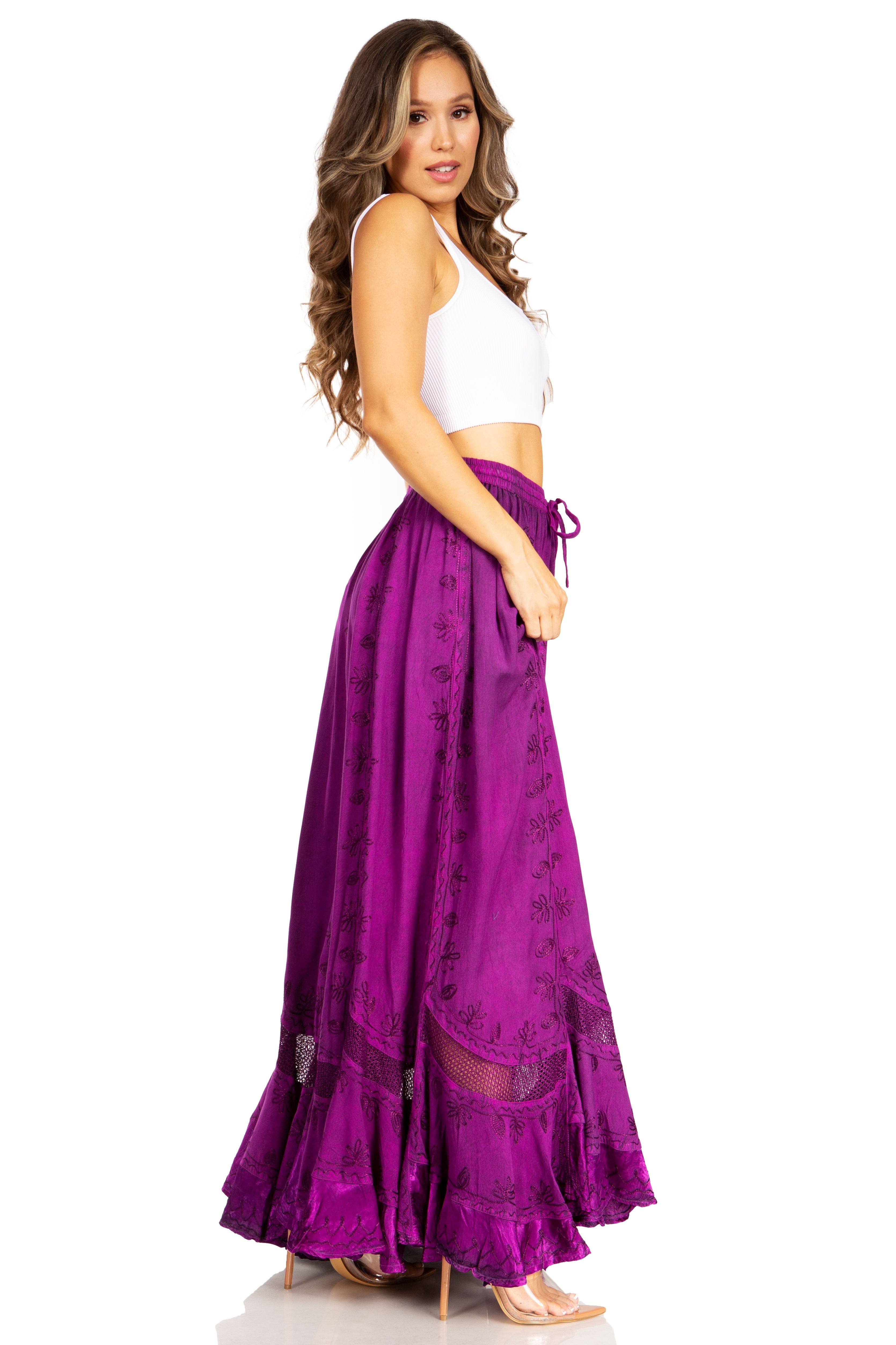 Woman wearing a white top and purple skirt on a white background