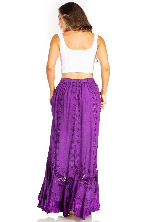 Woman wearing a long purple skirt with a white top on a white background