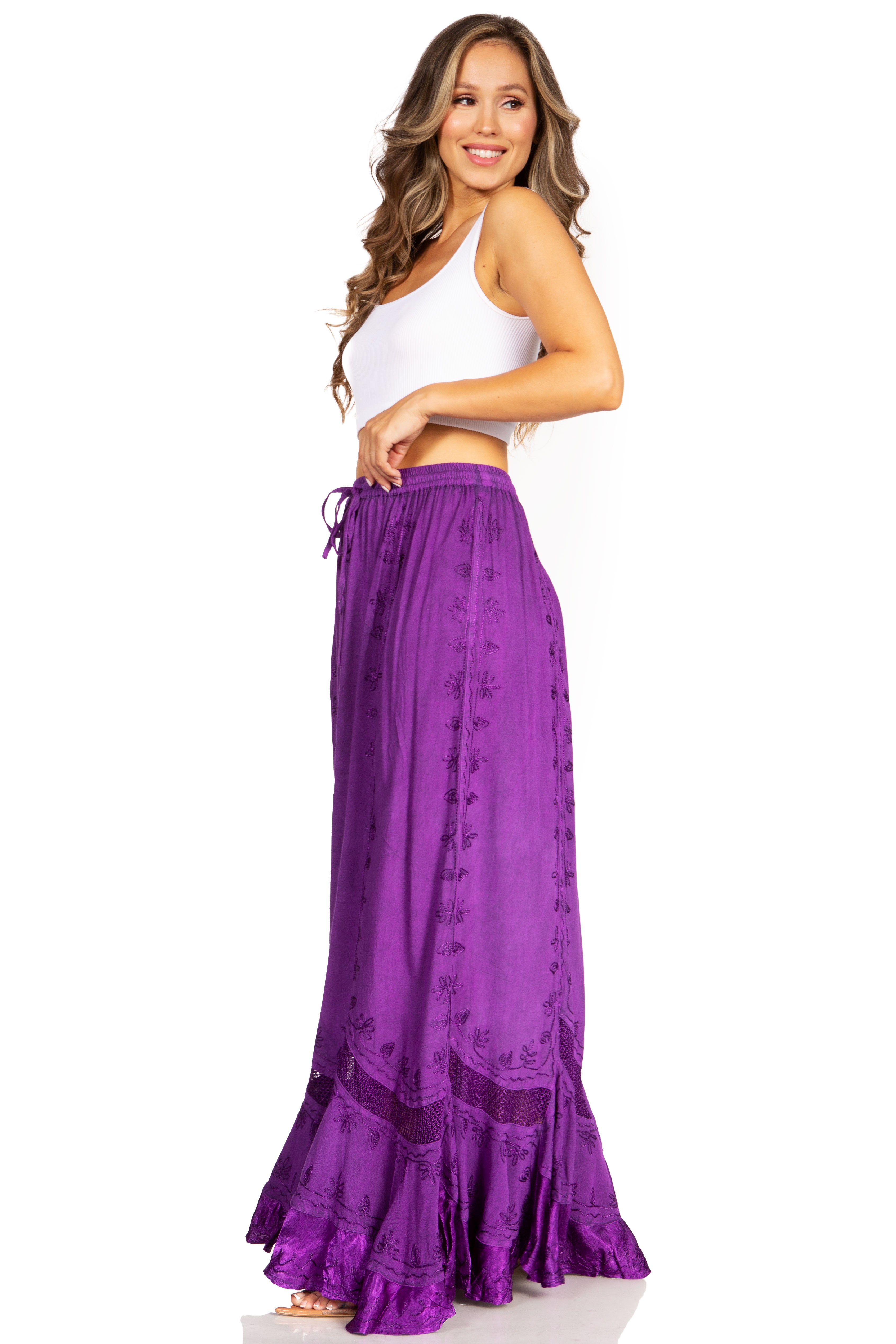 Woman wearing a white top and purple skirt on a white background