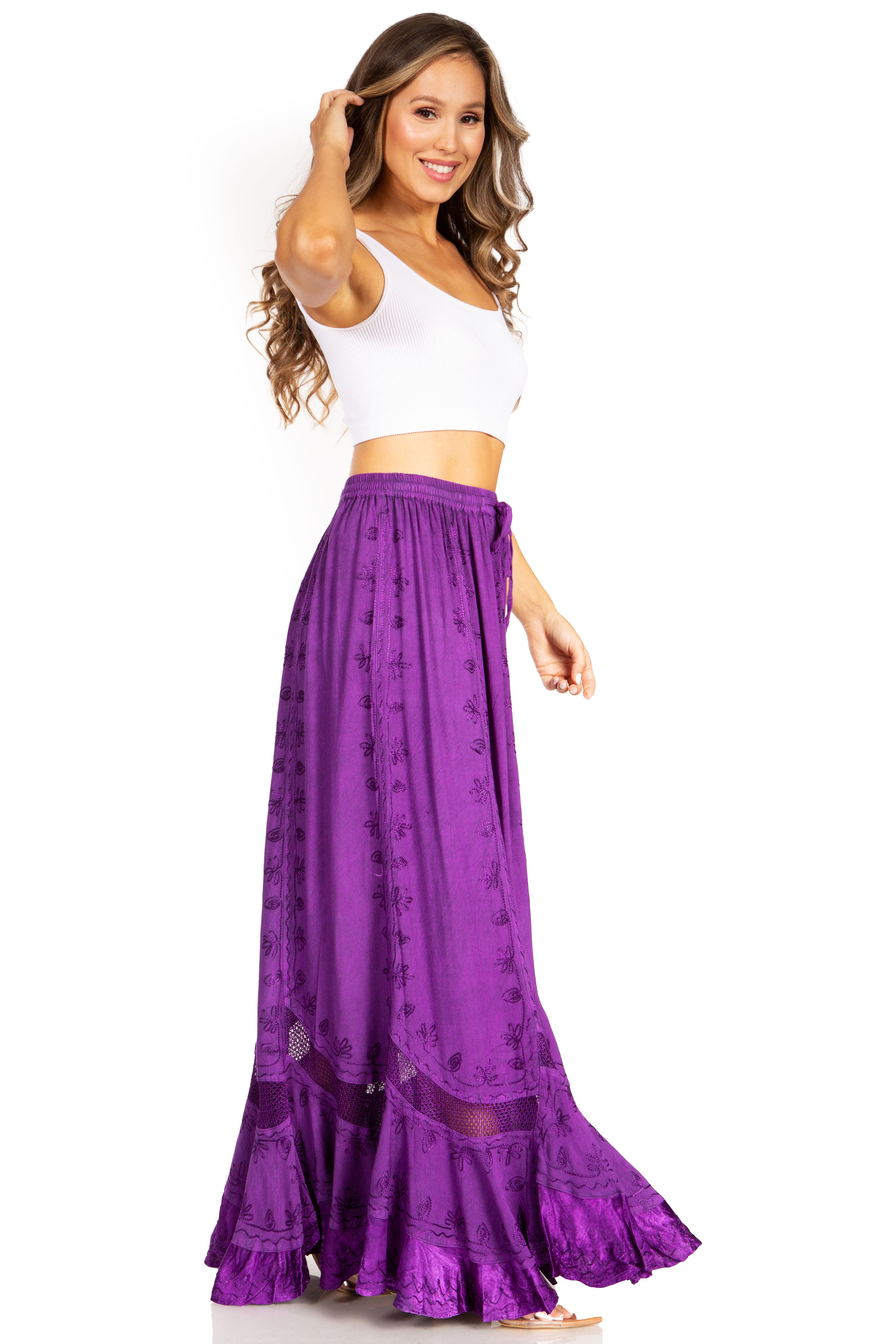 Woman wearing a white top and purple skirt on a white background
