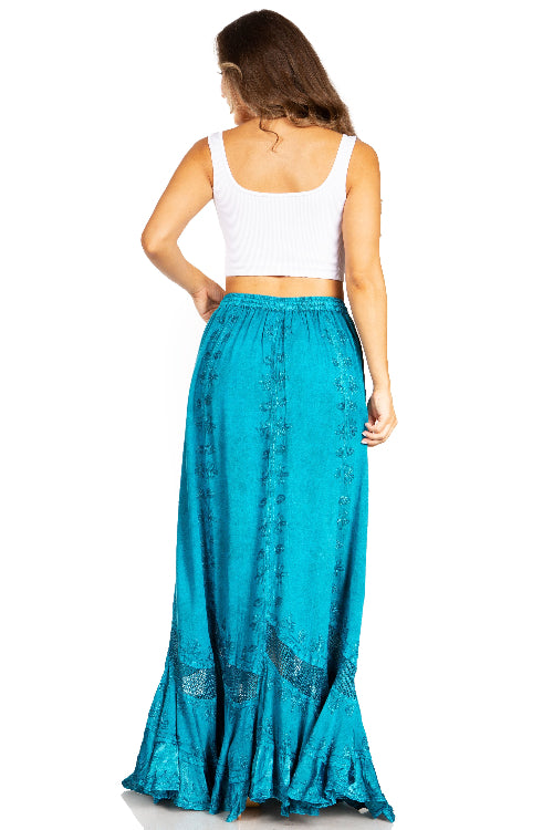 Woman wearing a white top and teal skirt on a white background