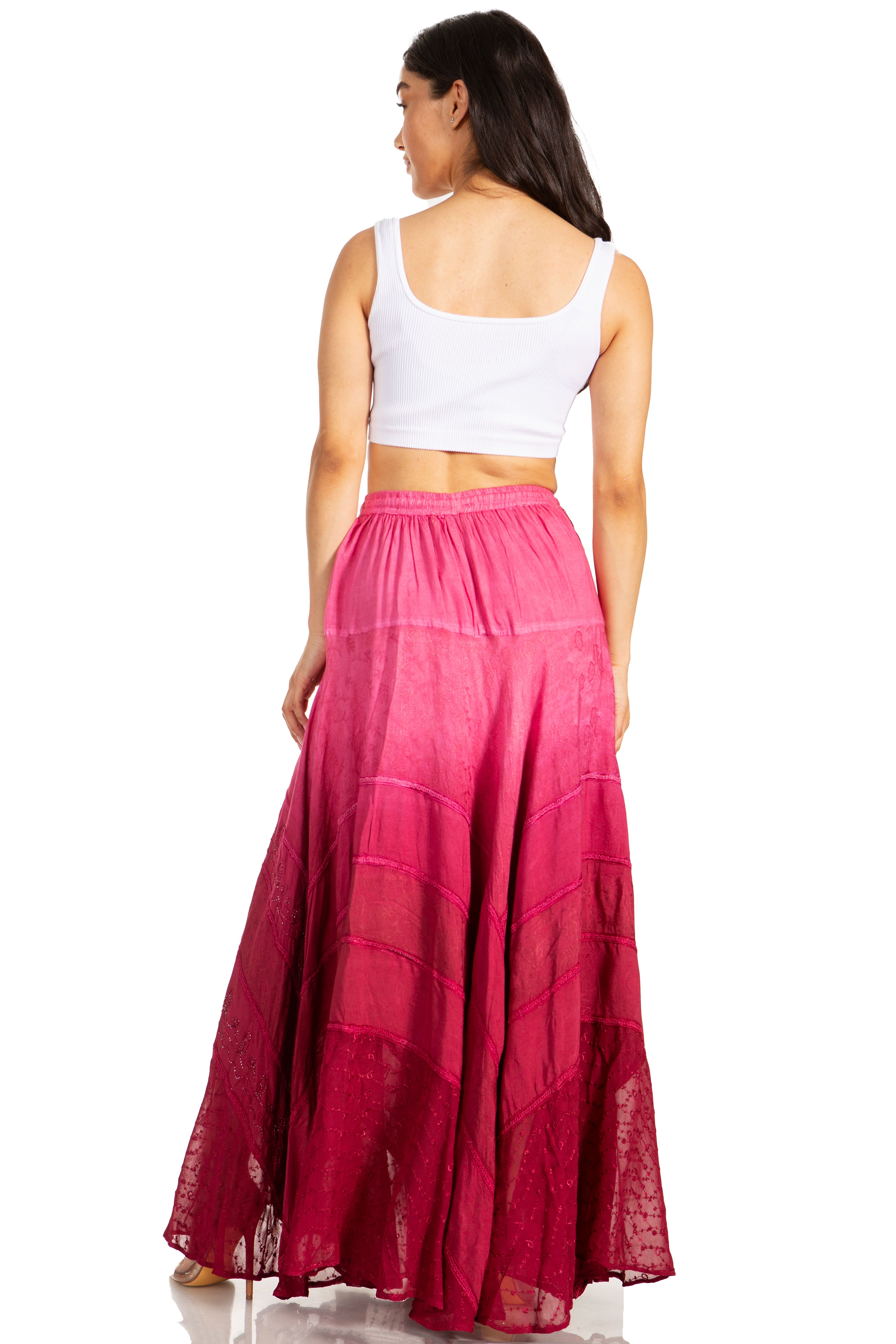Woman wearing a white top and pink skirt on a white background