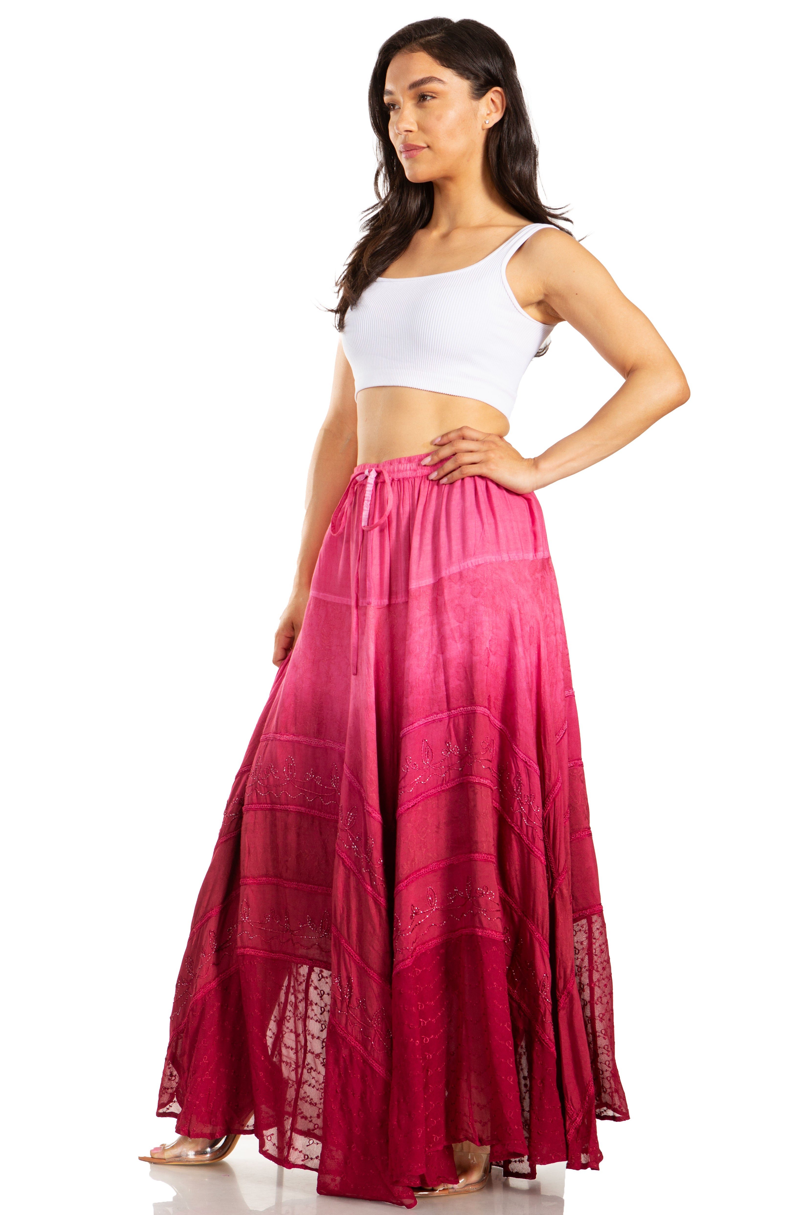 Woman wearing a white top and pink skirt on a white background