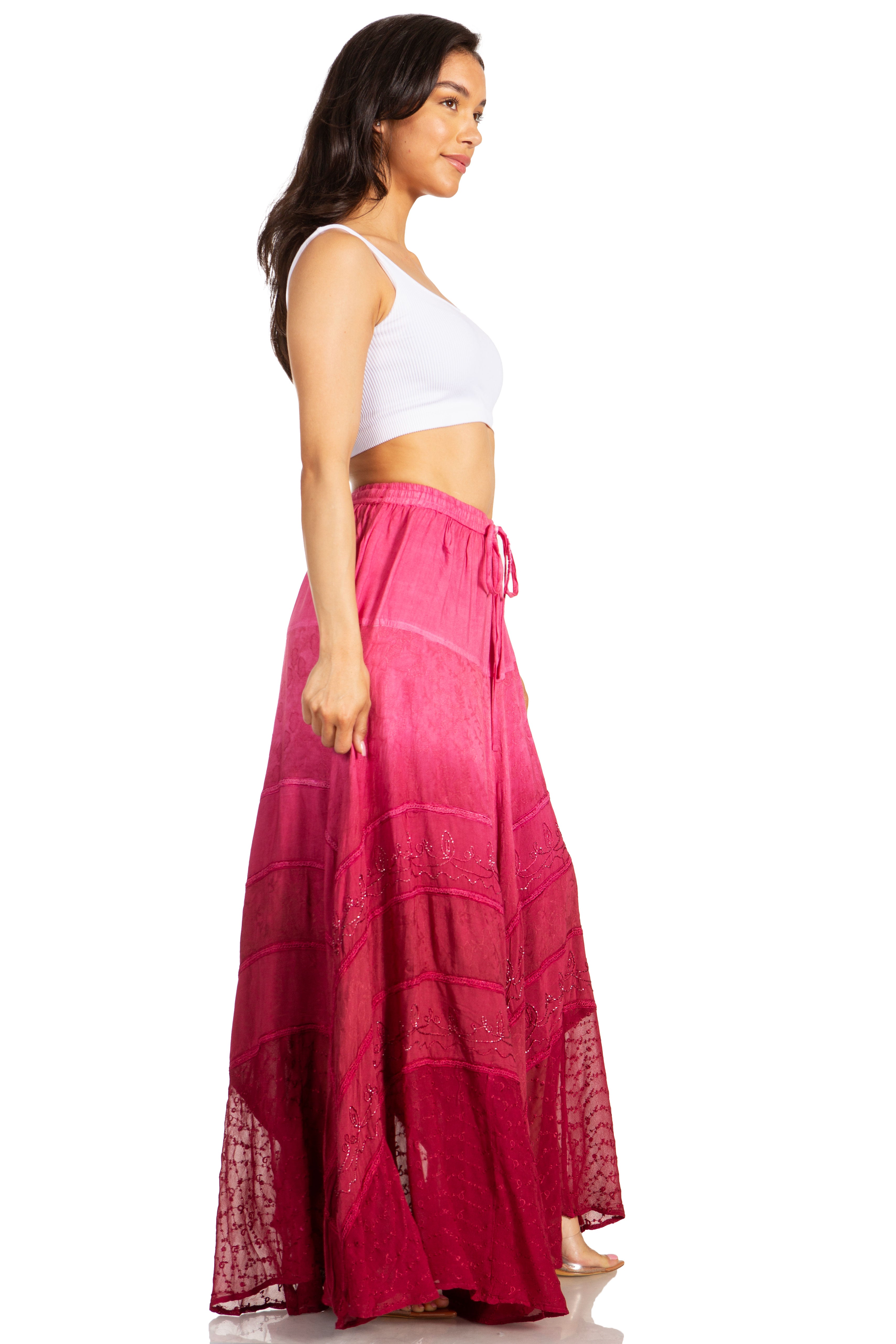 Woman wearing a white top and pink skirt on a white background