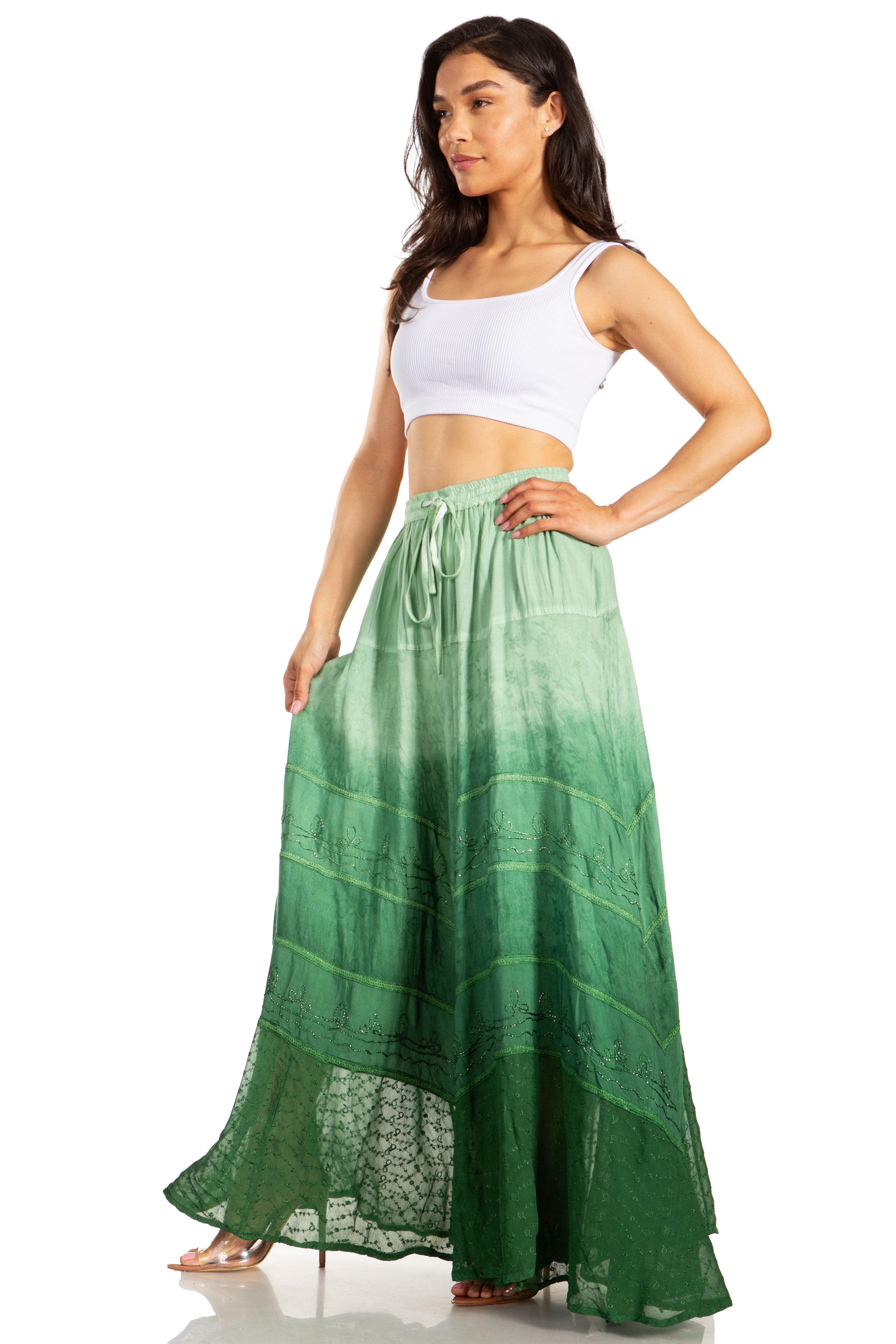 Woman wearing a green ombre skirt with a white top on a white background