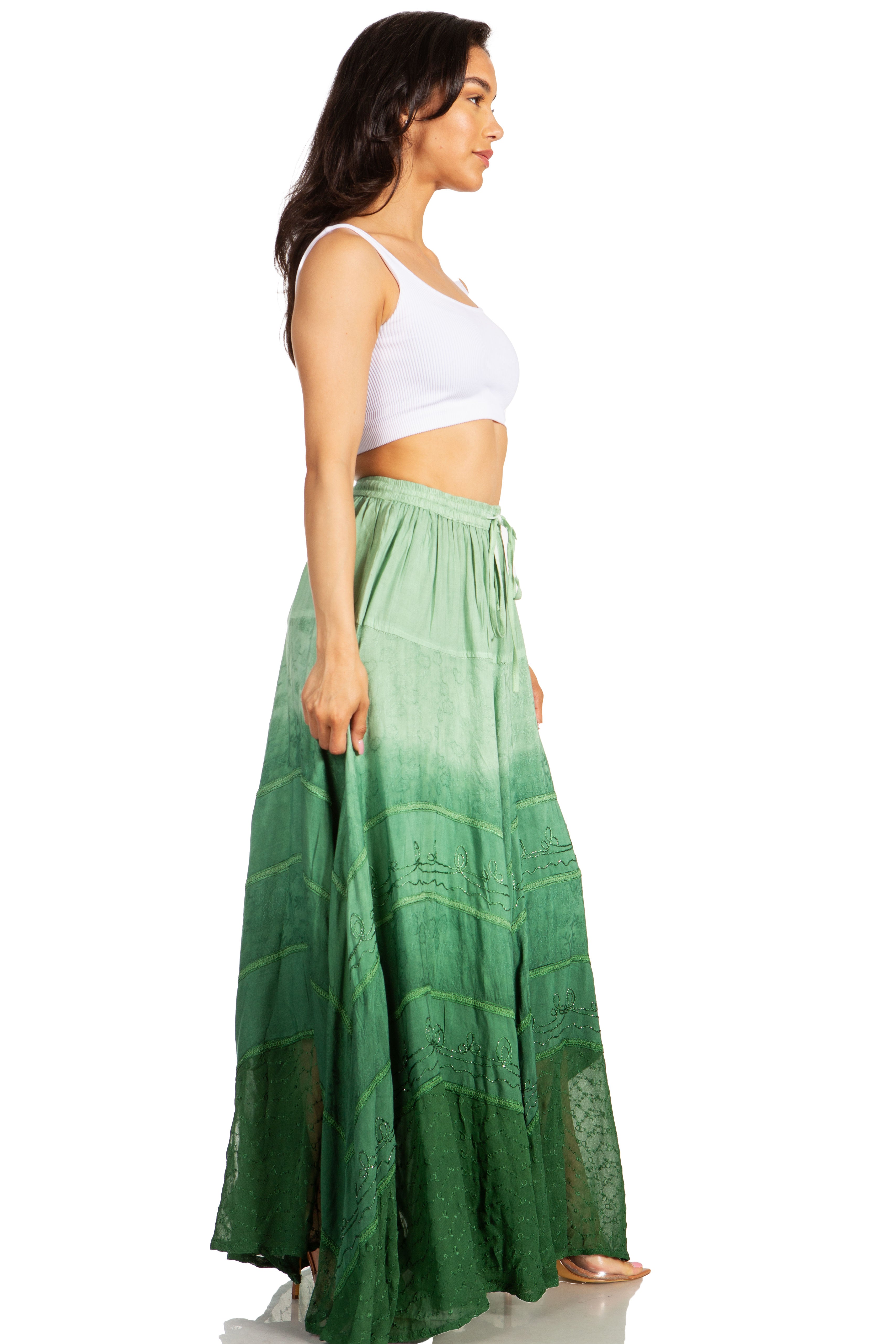 Woman wearing a white top and green skirt on a white background