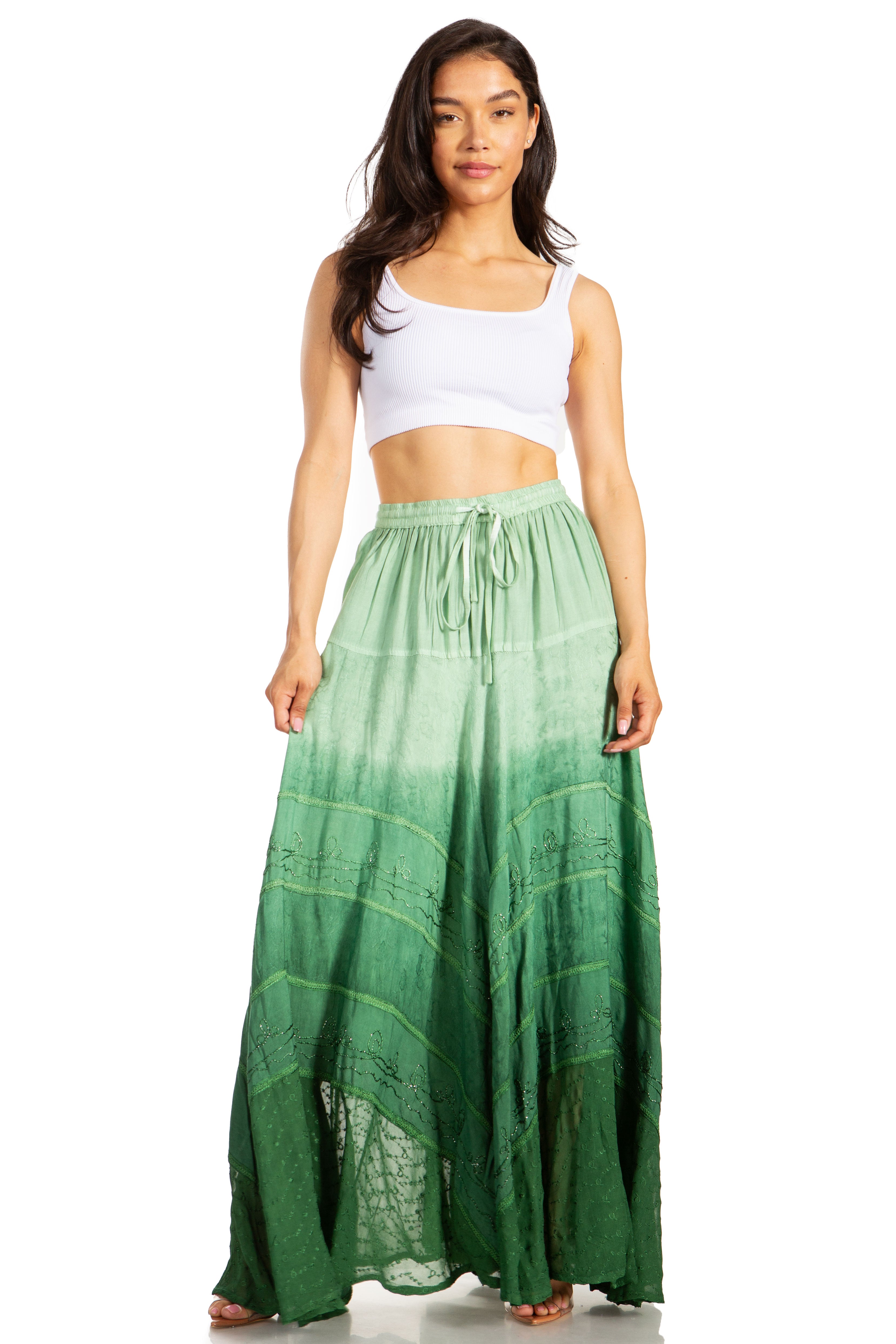 Woman wearing a white top and green ombre skirt on a white background