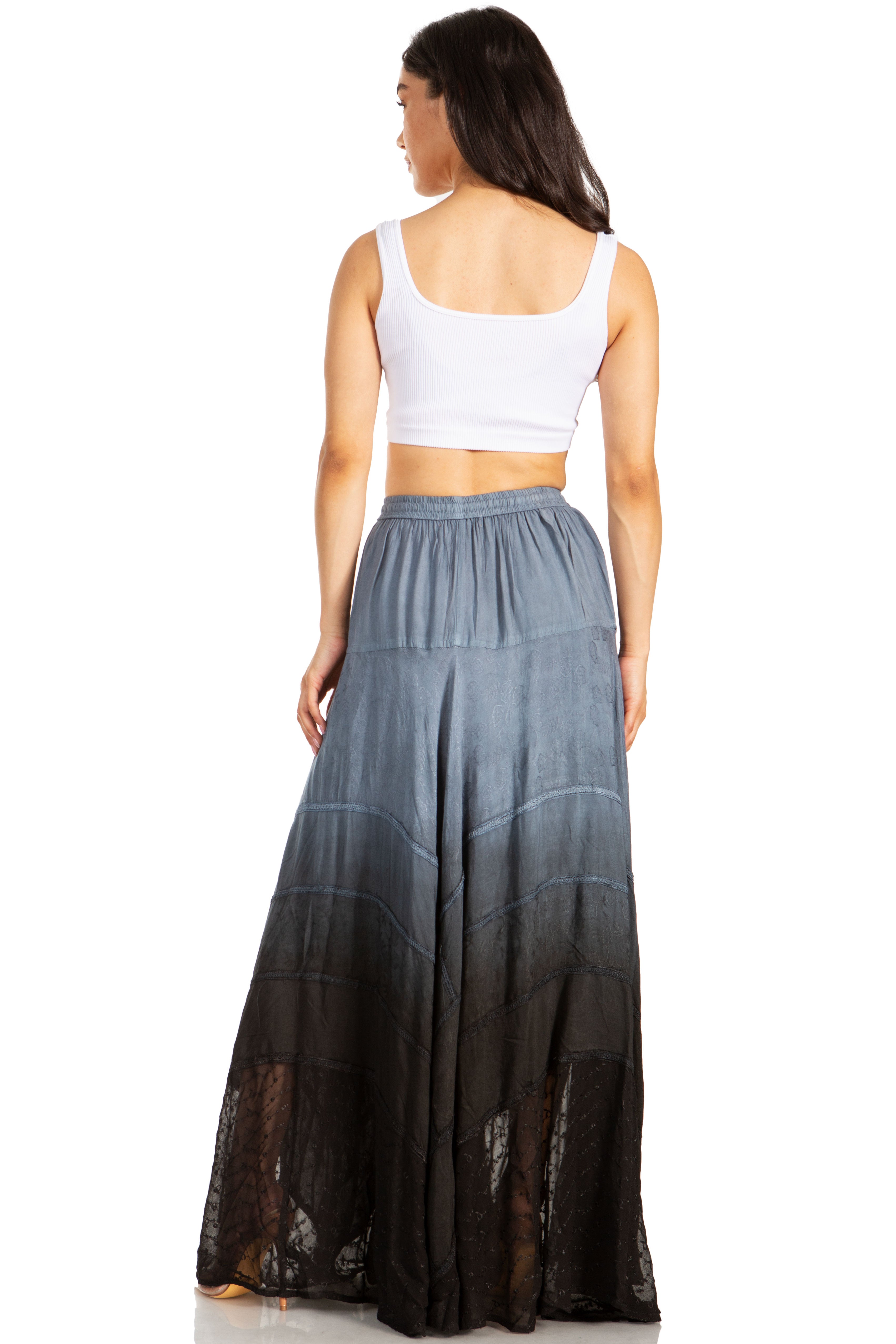 Woman wearing a long, gradient skirt with a white top on a white background