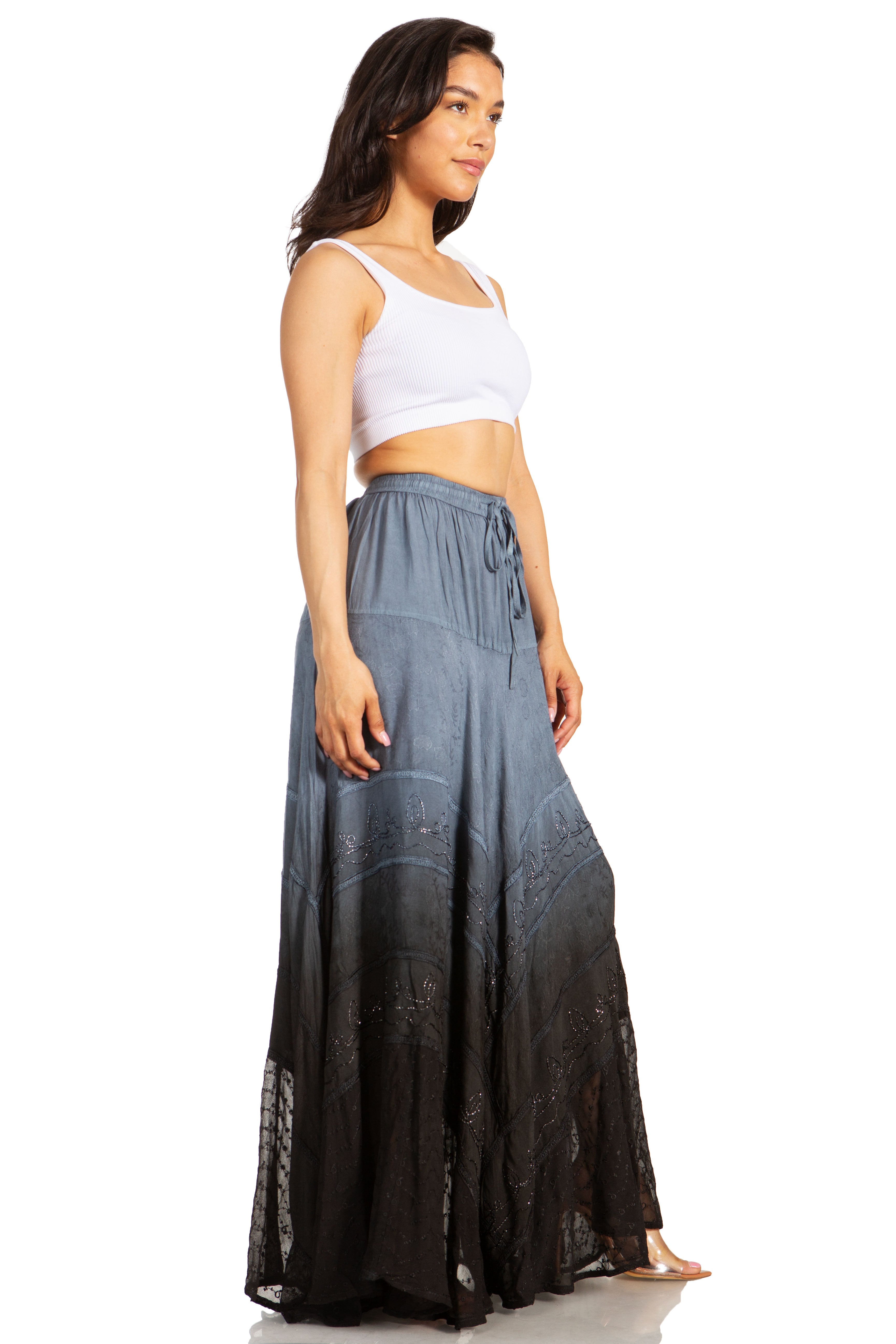 Woman wearing a white top and long dark gray skirt on a white background