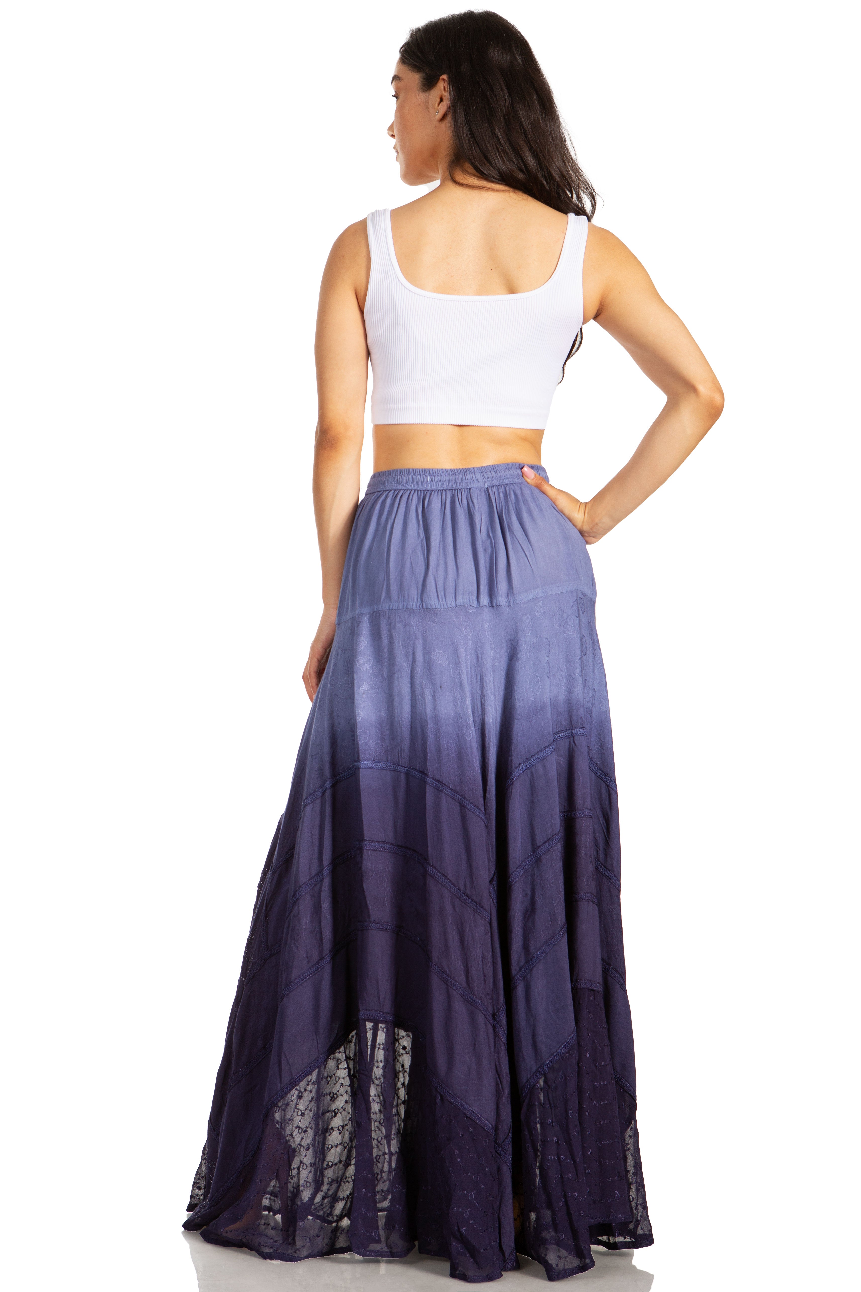 Woman wearing a long, gradient purple skirt on a white background