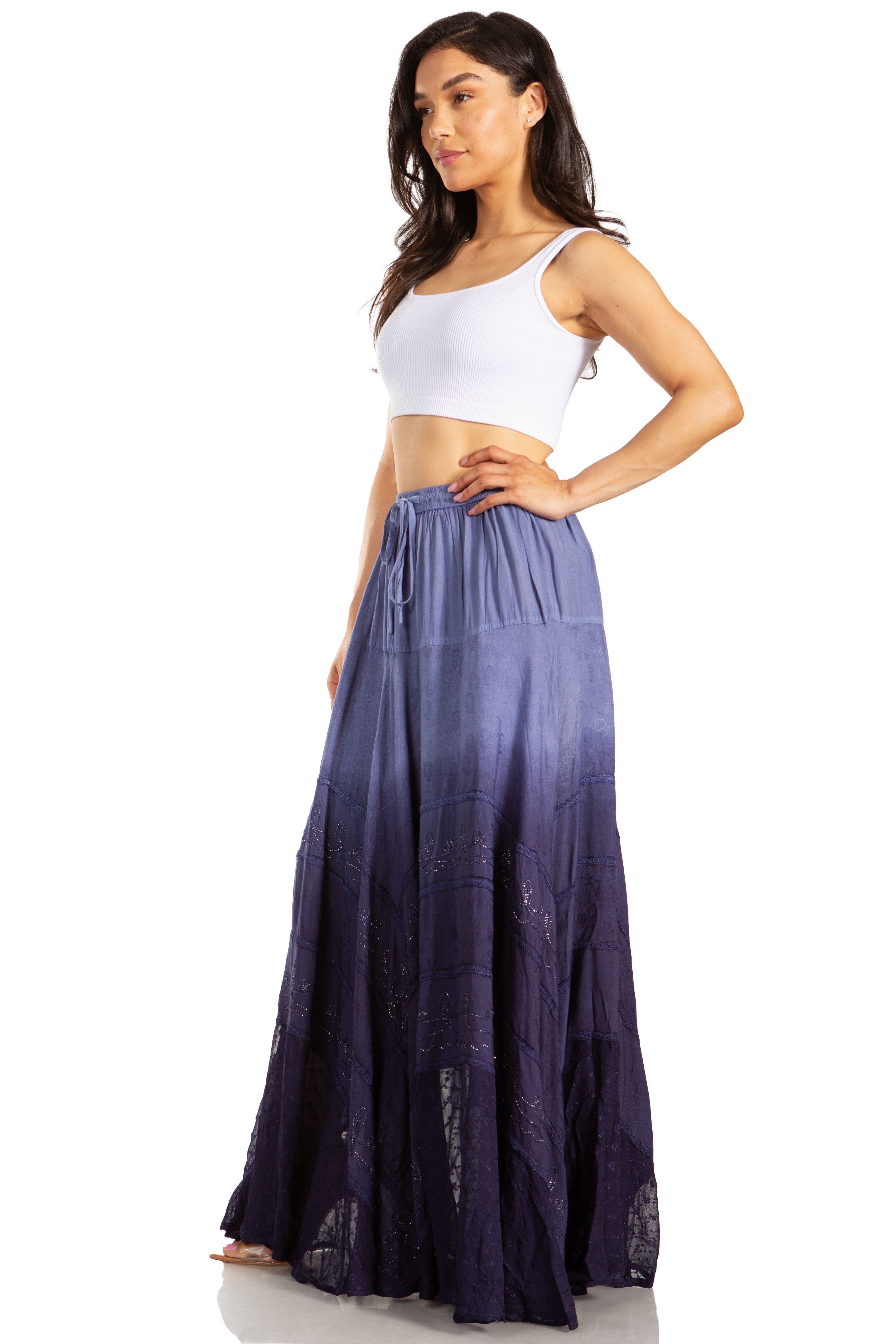 Woman wearing a white top and long purple skirt on a white background