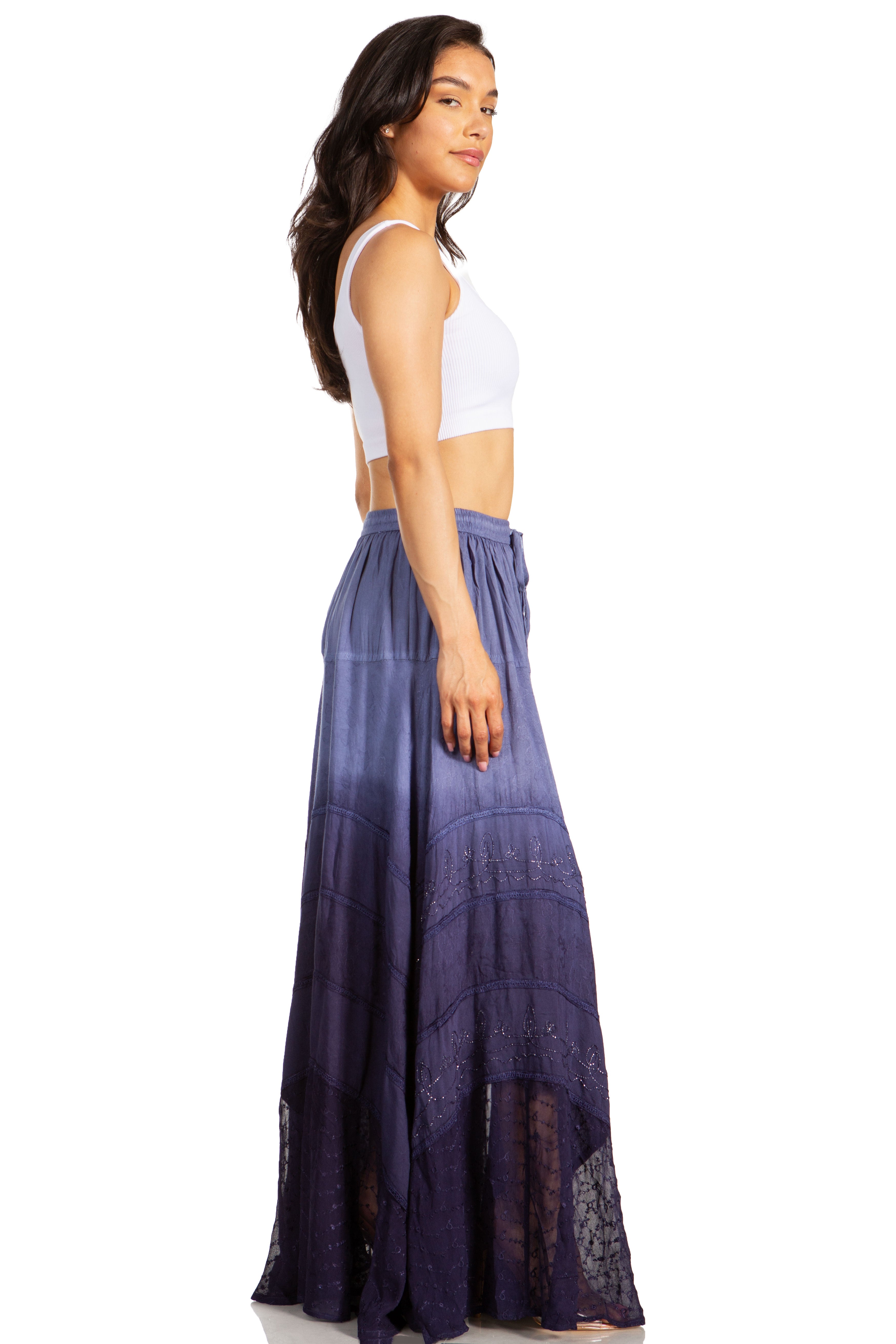 Woman wearing a long purple skirt with a white top on a white background