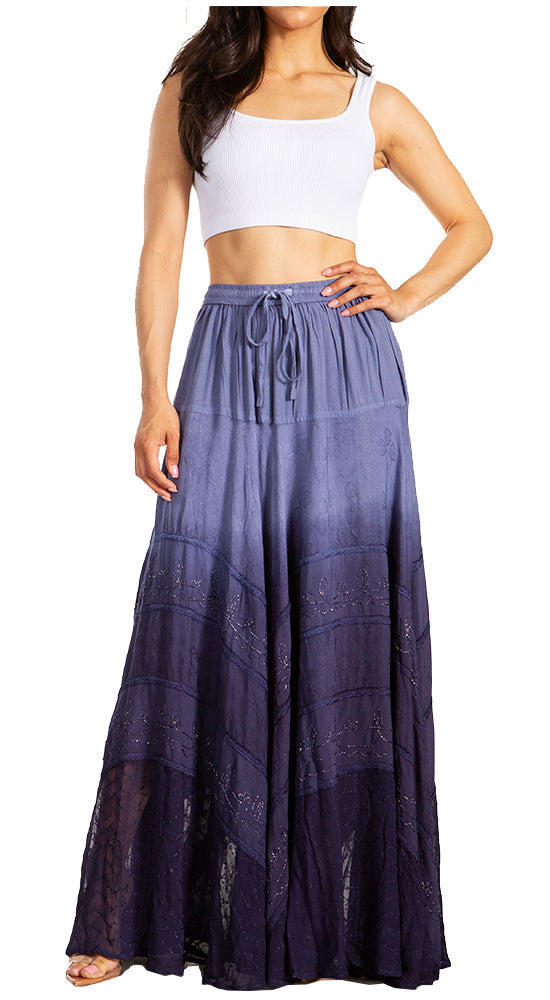 Woman wearing a long, patterned skirt with a white top on a white background