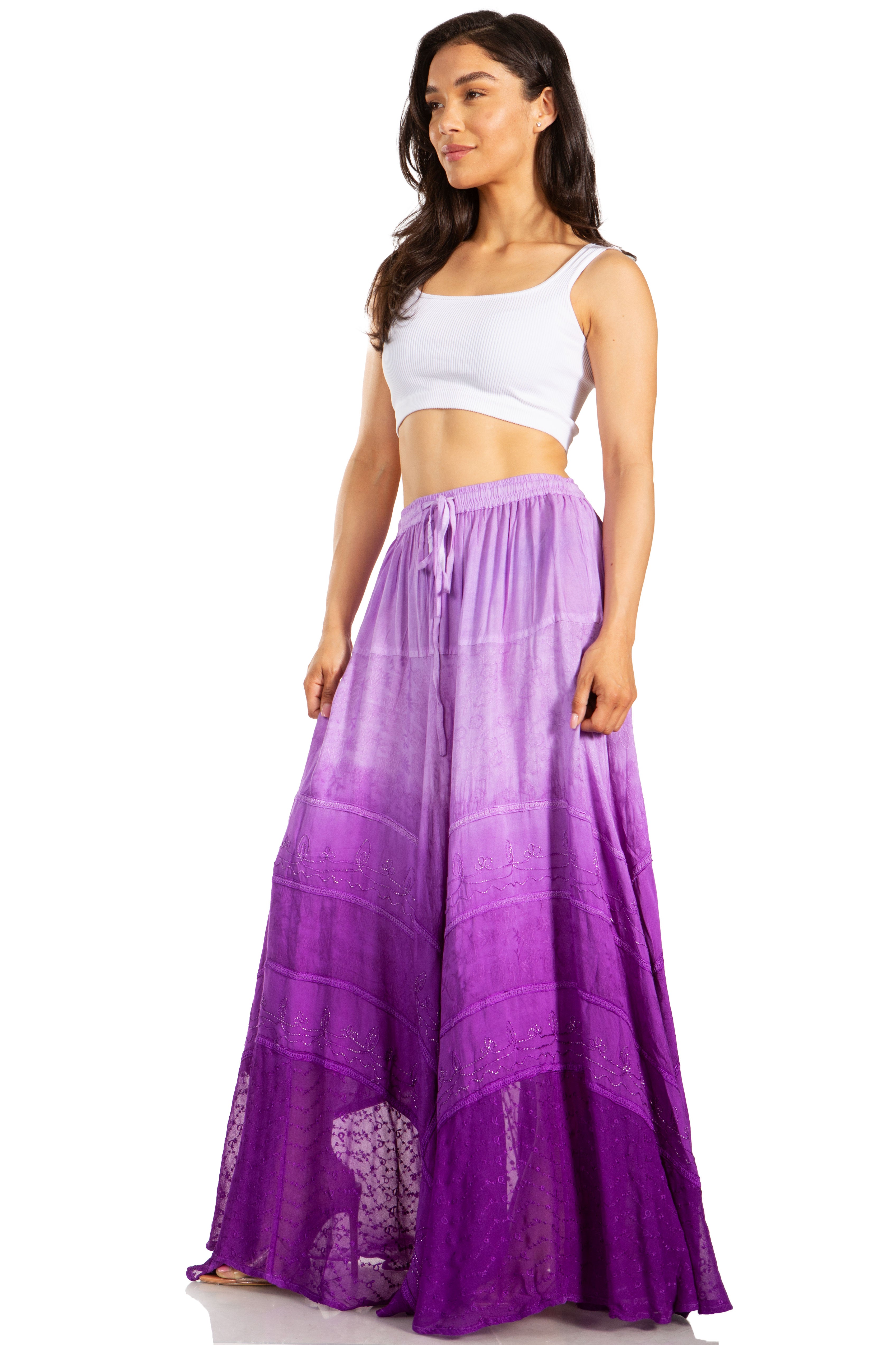 Woman wearing a long purple skirt with a white top on a white background