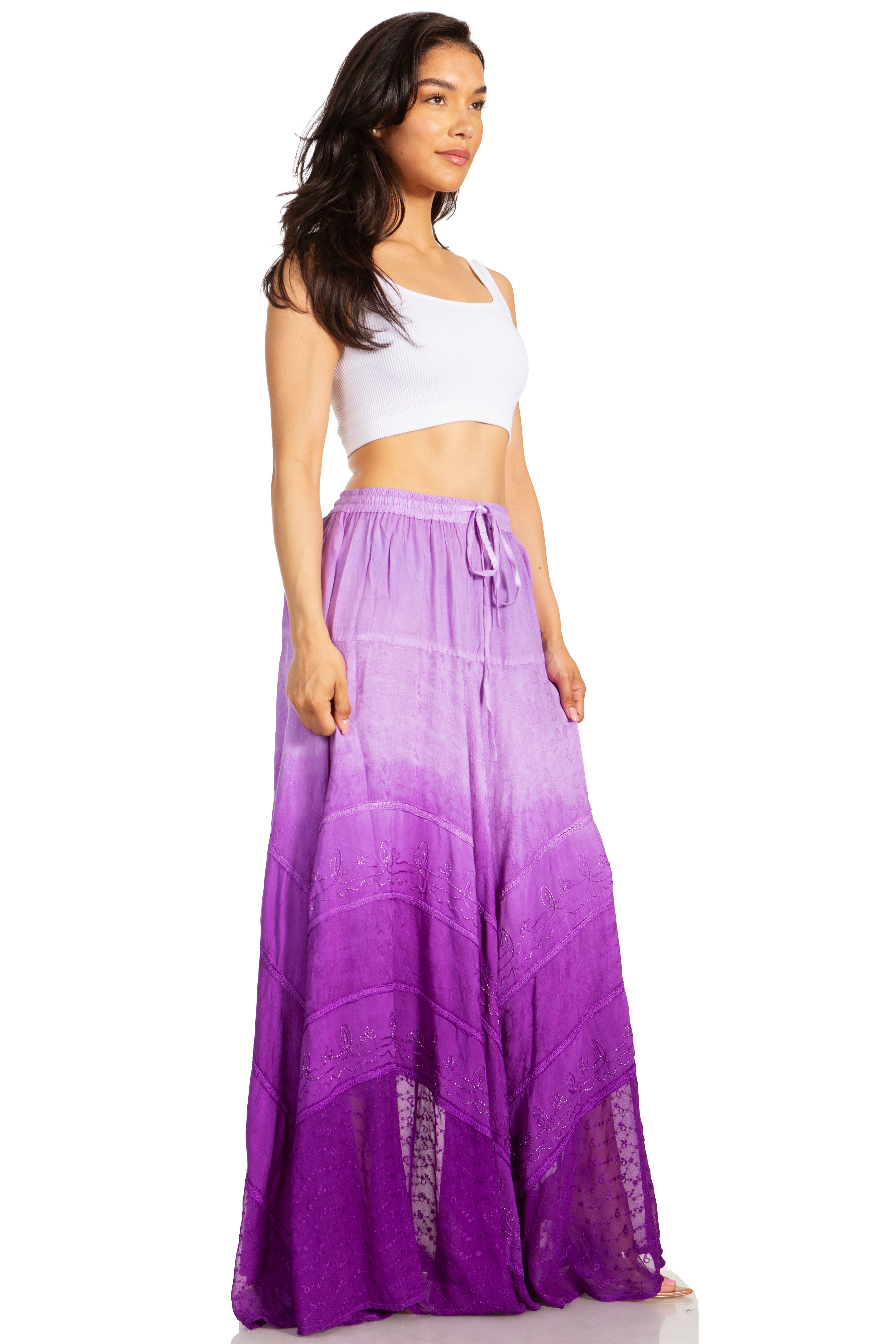 Woman wearing a white top and purple ombre skirt on a white background