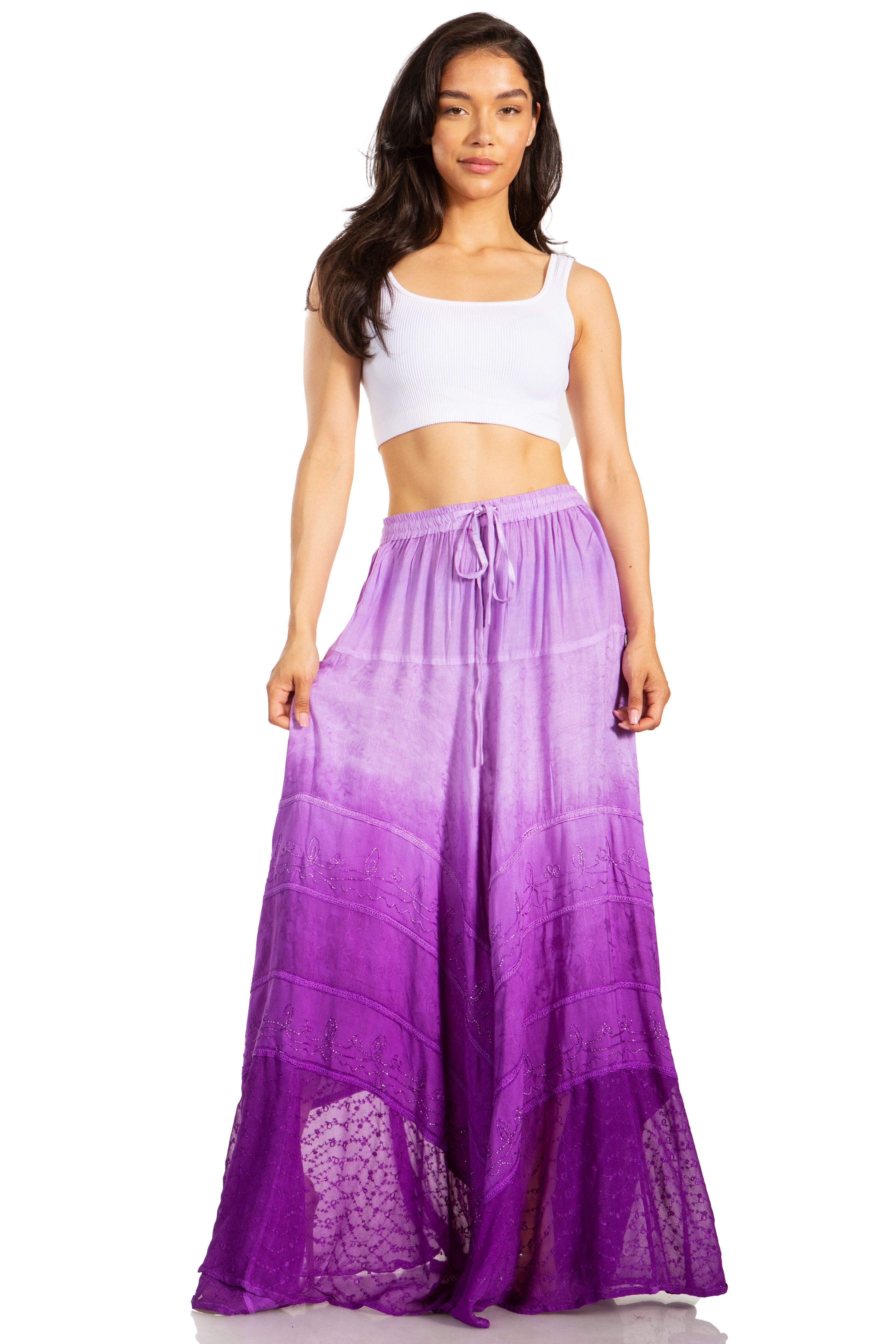 Woman wearing a white top and purple ombre skirt on a white background