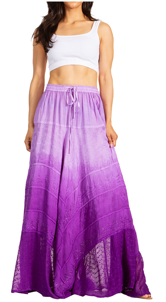 Woman wearing a white top and purple ombre skirt on a white background