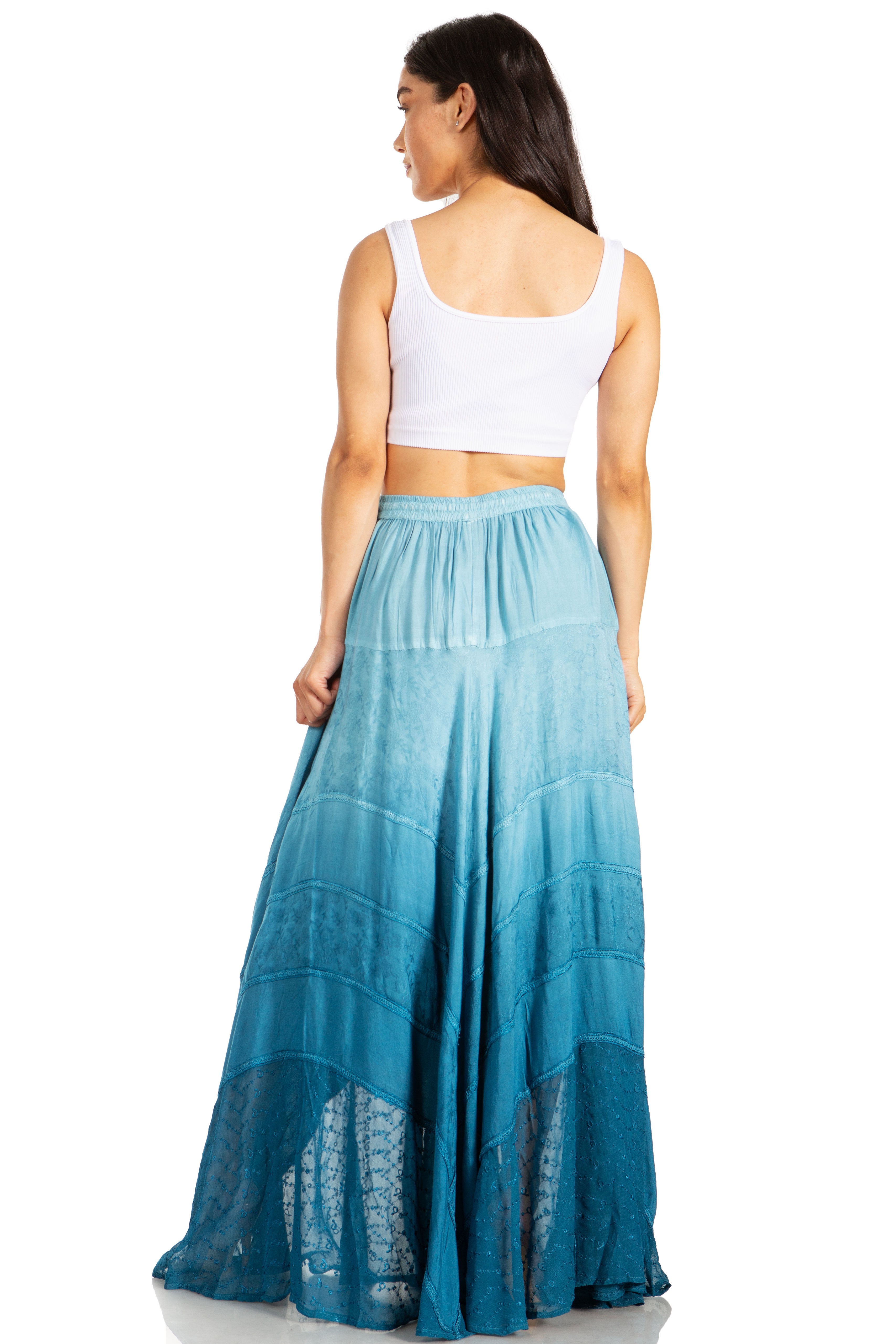 Woman wearing a white top and blue ombre skirt on a white background