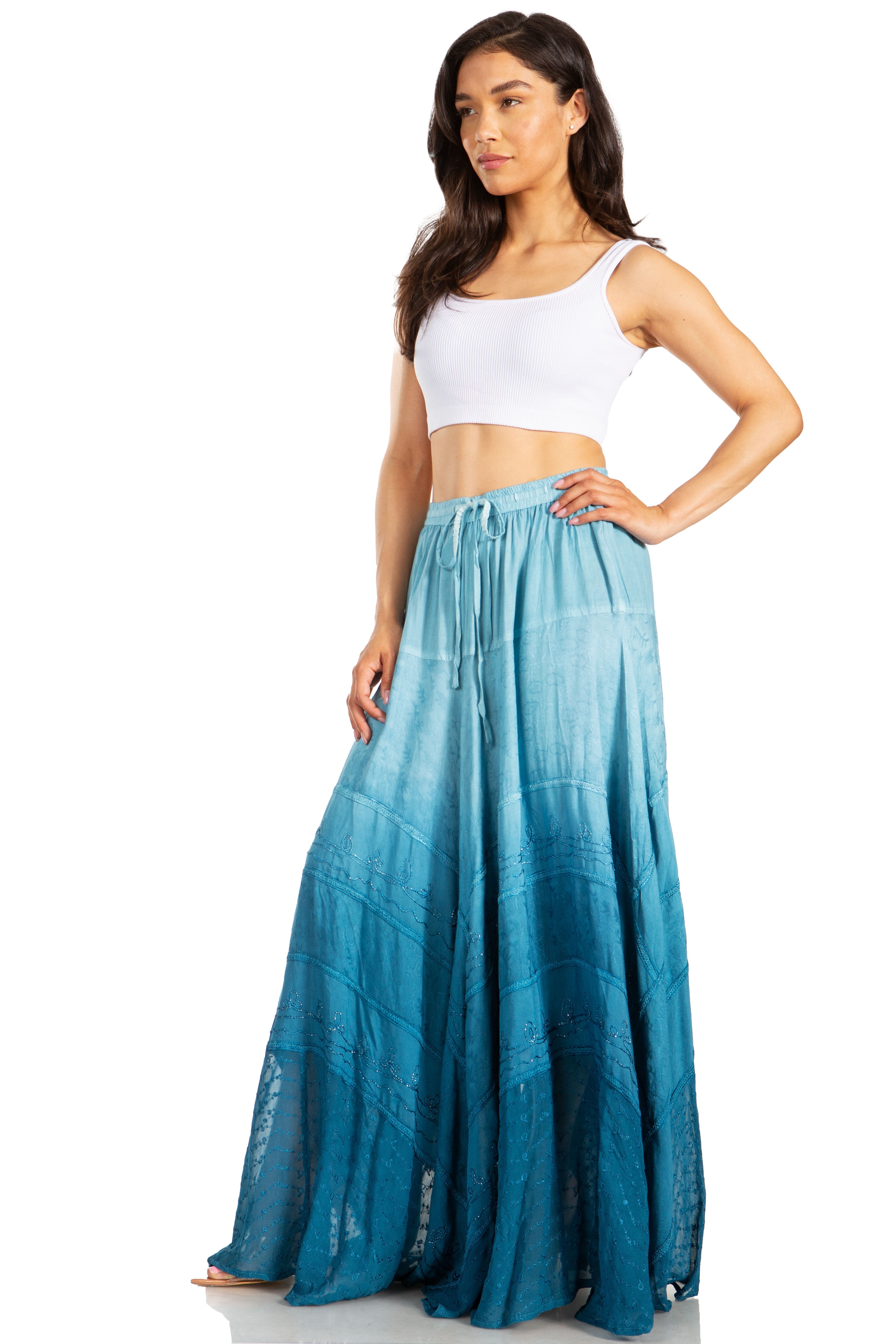 Woman wearing a white top and blue ombre skirt on a white background