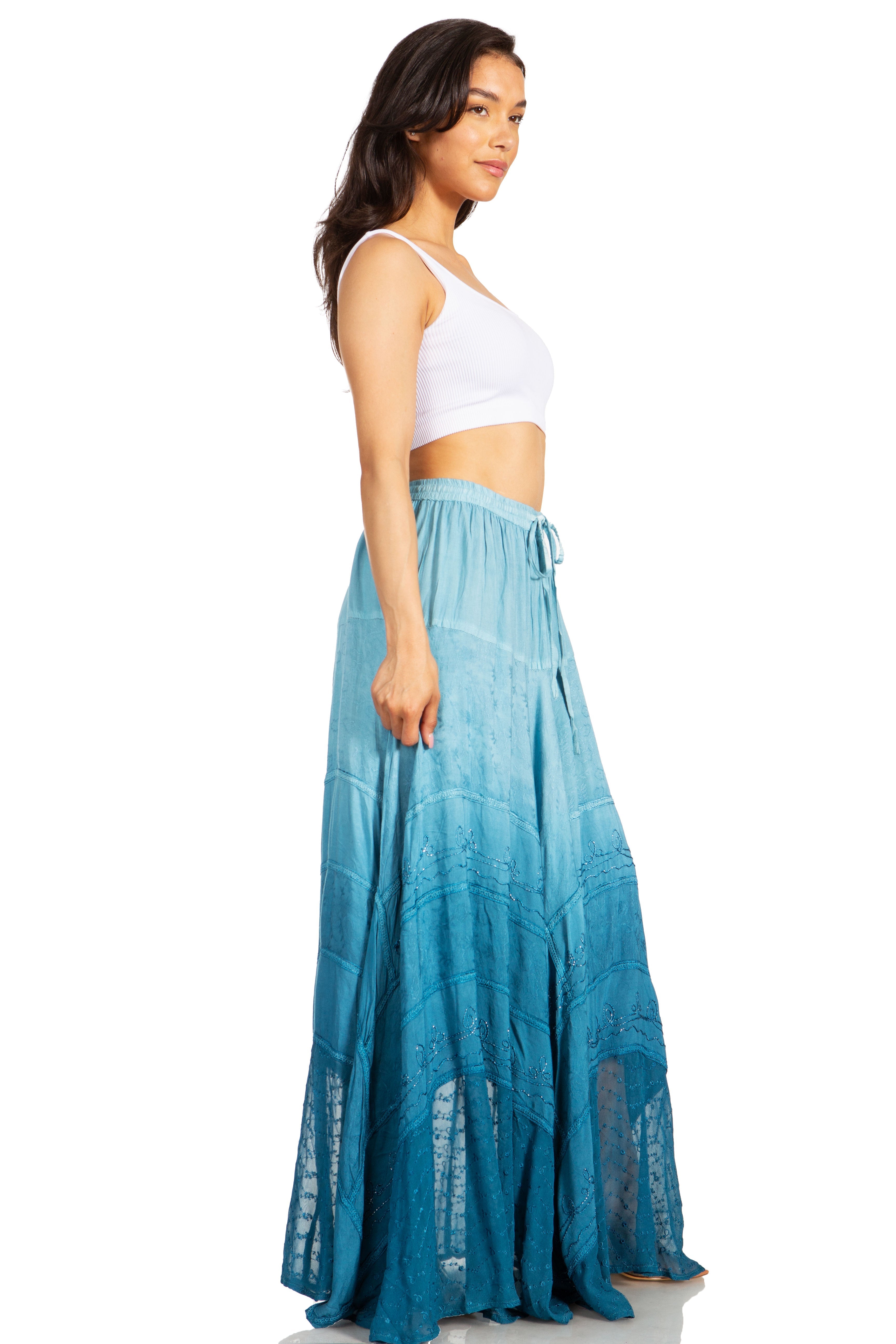 Woman wearing a long blue skirt and white top on a white background