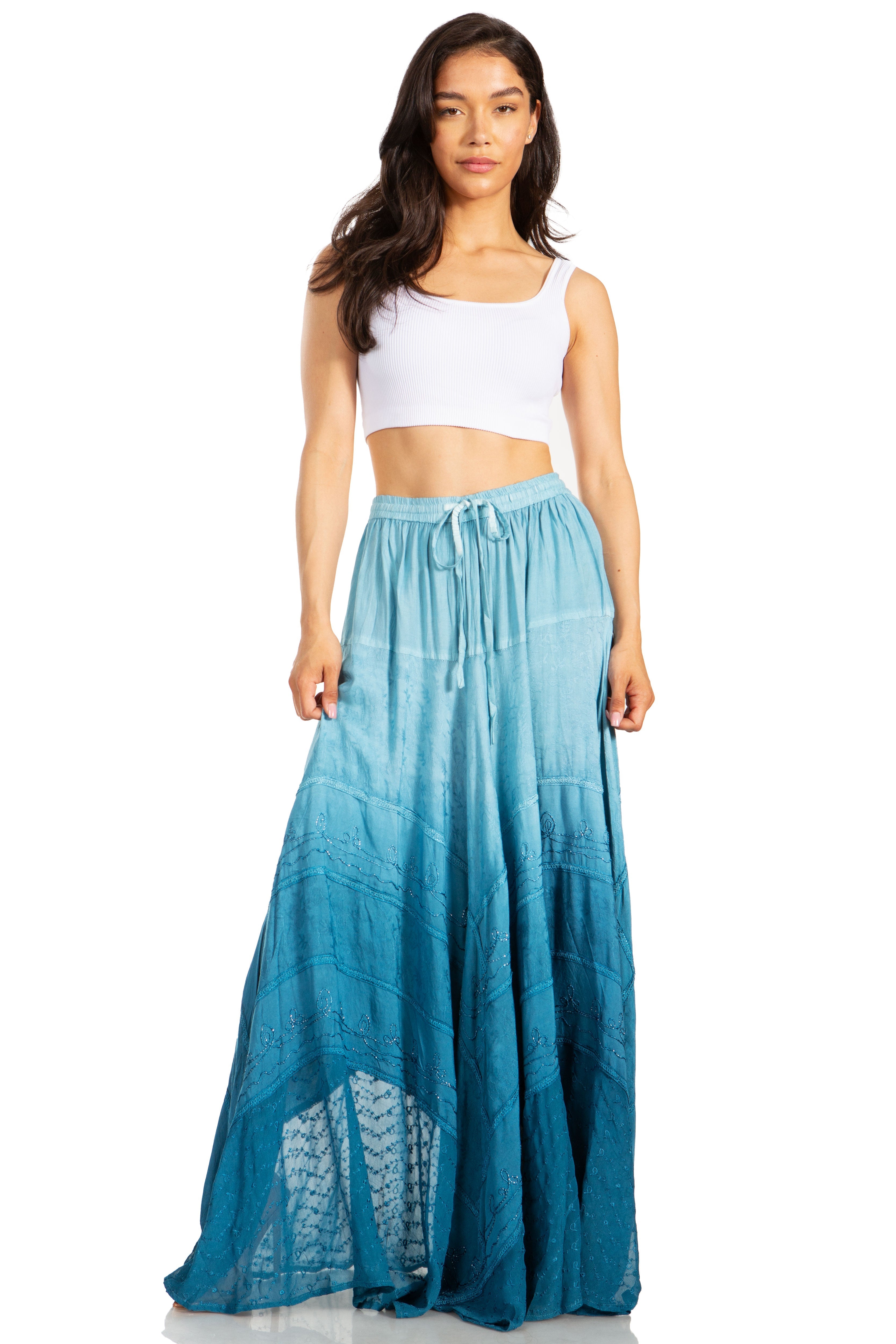 Woman wearing a white top and blue ombre skirt on a white background