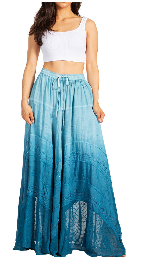 Woman wearing a white top and blue maxi skirt on a white background